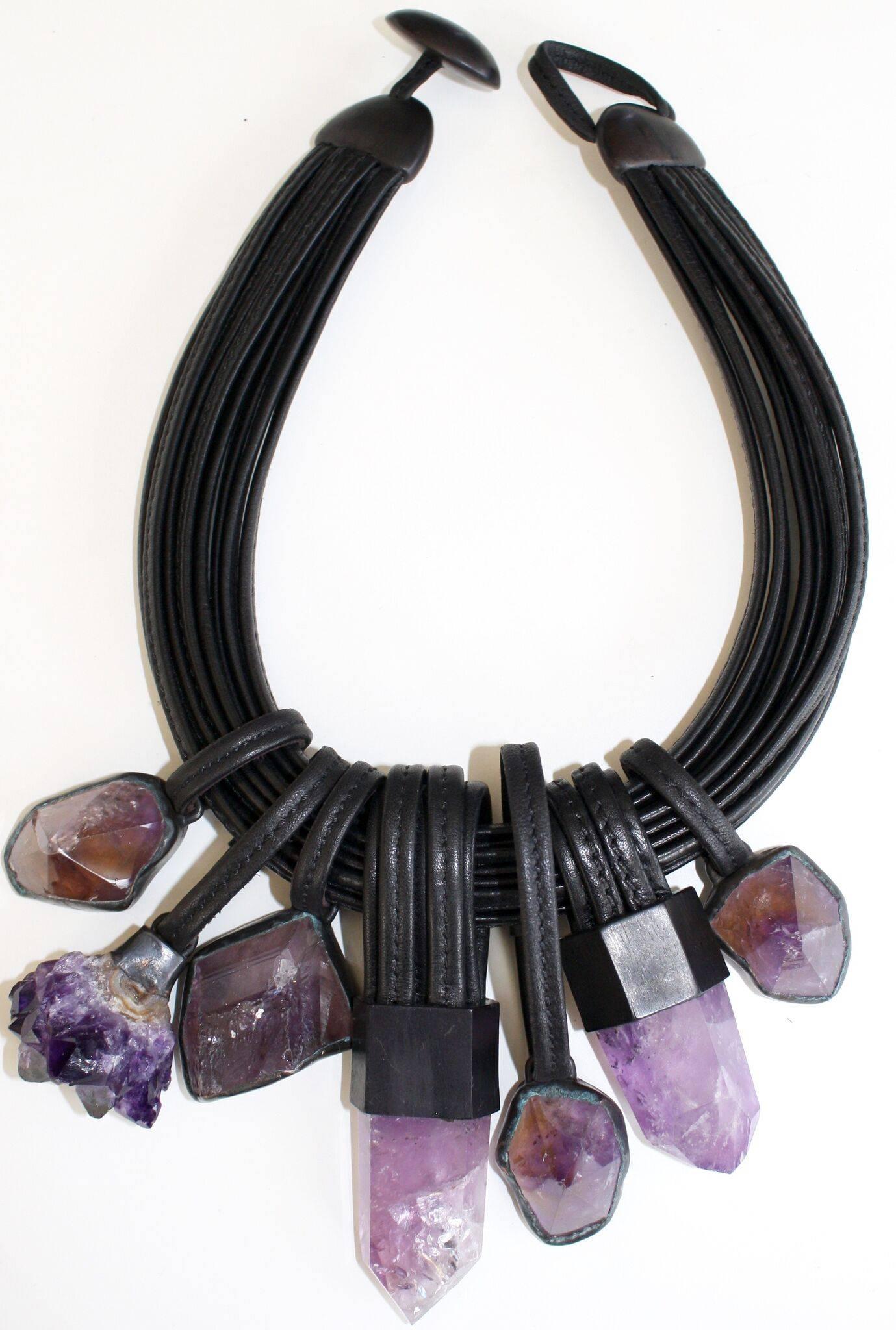 One of a kind statement necklace made with multiple strands of leather and amethyst drops from Monies.

17