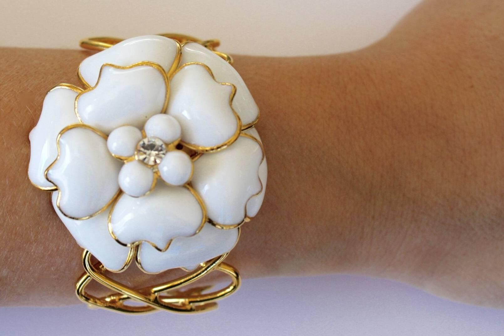 Pate de verre glass camellia with crystal center bracelet. Cuff portion of bracelet is made with gold plated brass wire in a crisscross pattern. Cuff is soft and can be sized for both small and large wrists. A modern take on a class chic style.