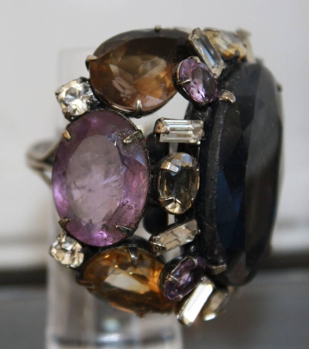 Amethyst, cabochon sapphire, smokey quartz, lemon quartz, and Swarovski crystal ring from Iradj Moini. 

Inside adjustable sizer allows ring to fit sizes 4 - 7.5

