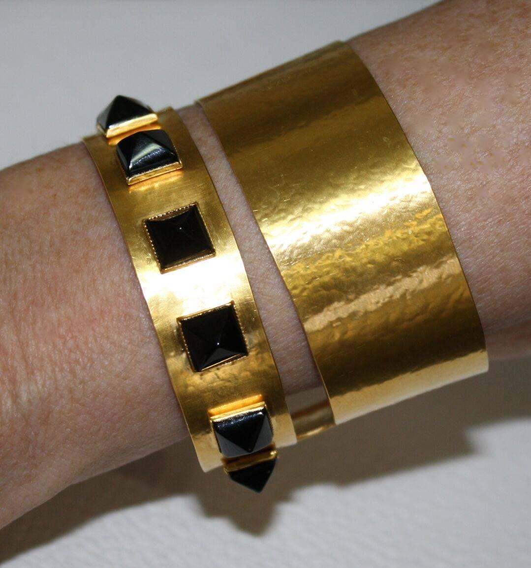 Gilded brass cuff bracelet with black onyx studs from Herve van der Straeten.

Cuff is very soft and can be molded to fit any wrist. 

Hervé Van der Straeten was born in 1965 and is an independent artist-designer. Having first become known for