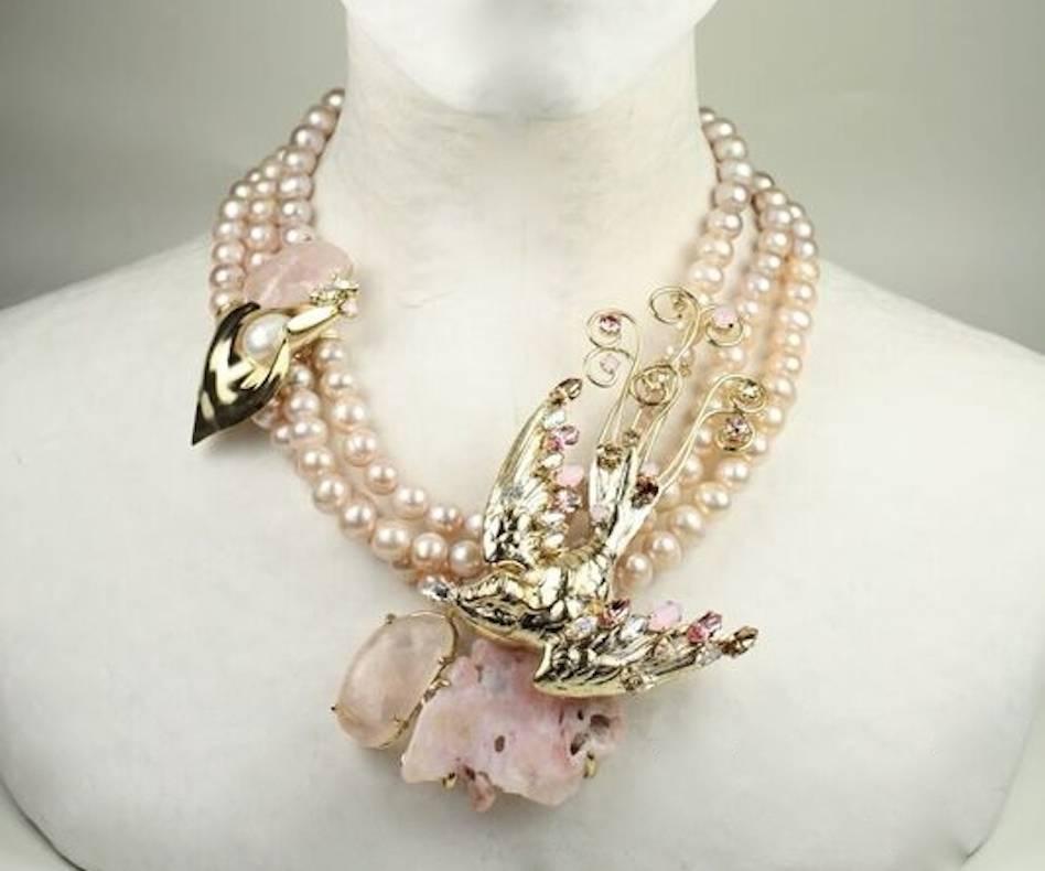 Philippe Ferrandis necklace made with pink glass pearls, pink quartz, Swarovski crystals, and gold metallic treatment. Bird motif is extraordinary and unusual!

15