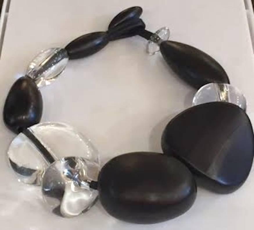 Ebony wood and Acrylic bead necklace strung on leather from Monies. 

Designer Biography:

Monies is a Danish jewelry company founded by Gerda and Nikolai Monies. We are trained goldsmiths with experience from Denmark, Germany, England, Italy