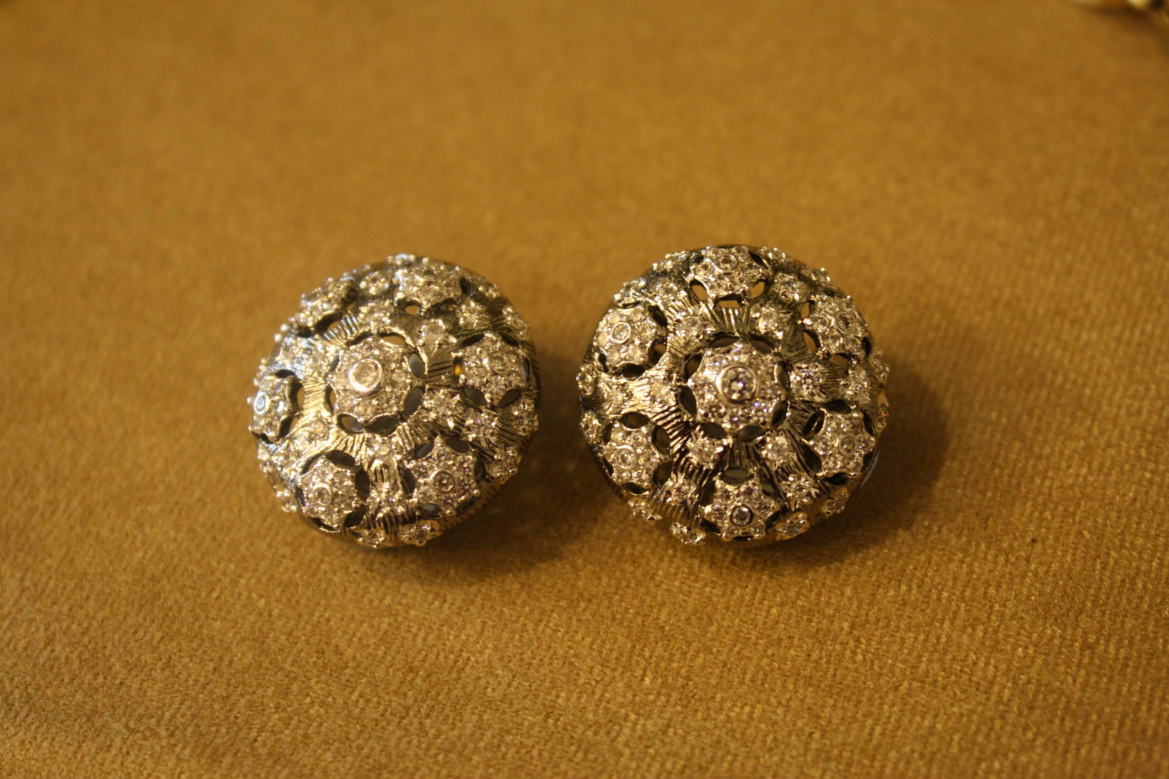 Sterling silver plated with rhodium clip earrings with Cubic Zirconia filigree detailing. 

1