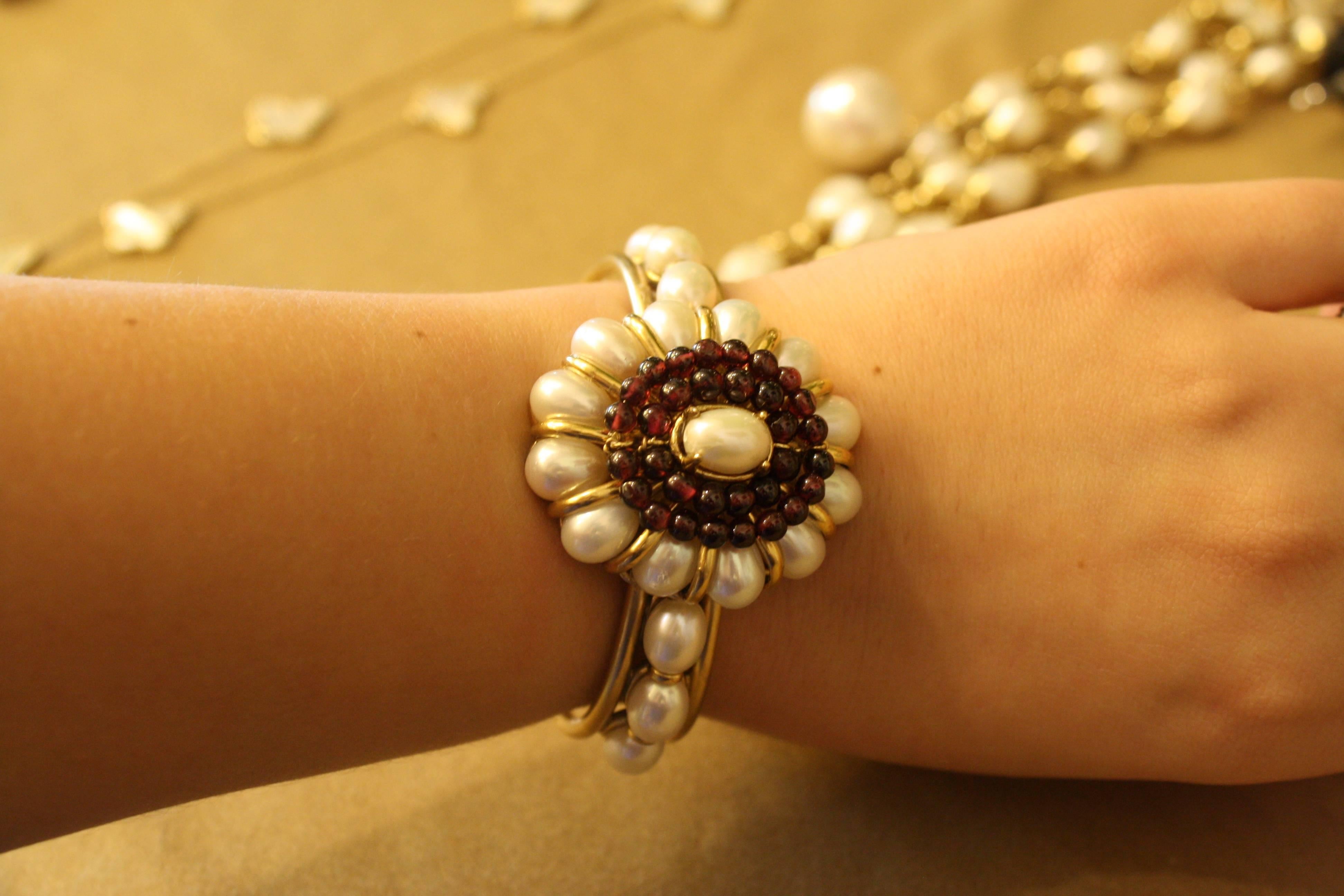 Goossens Paris natural pearl cuff bracelet with garnet detailing. Metal is bronze plated with gold. 

1.5