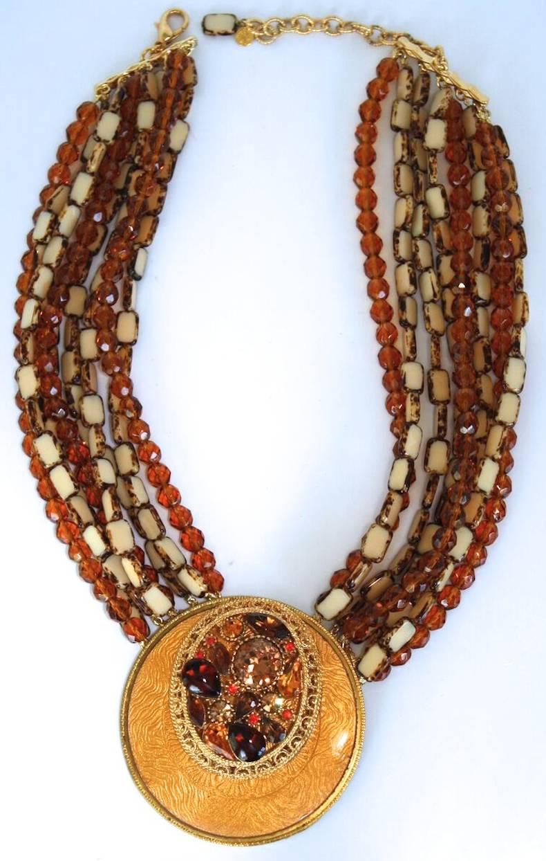 One of a kind gilded metal, lacquered medallion, Swarovski crystal, and handmade glass cabochon statement necklace from Francoise Montague.

18