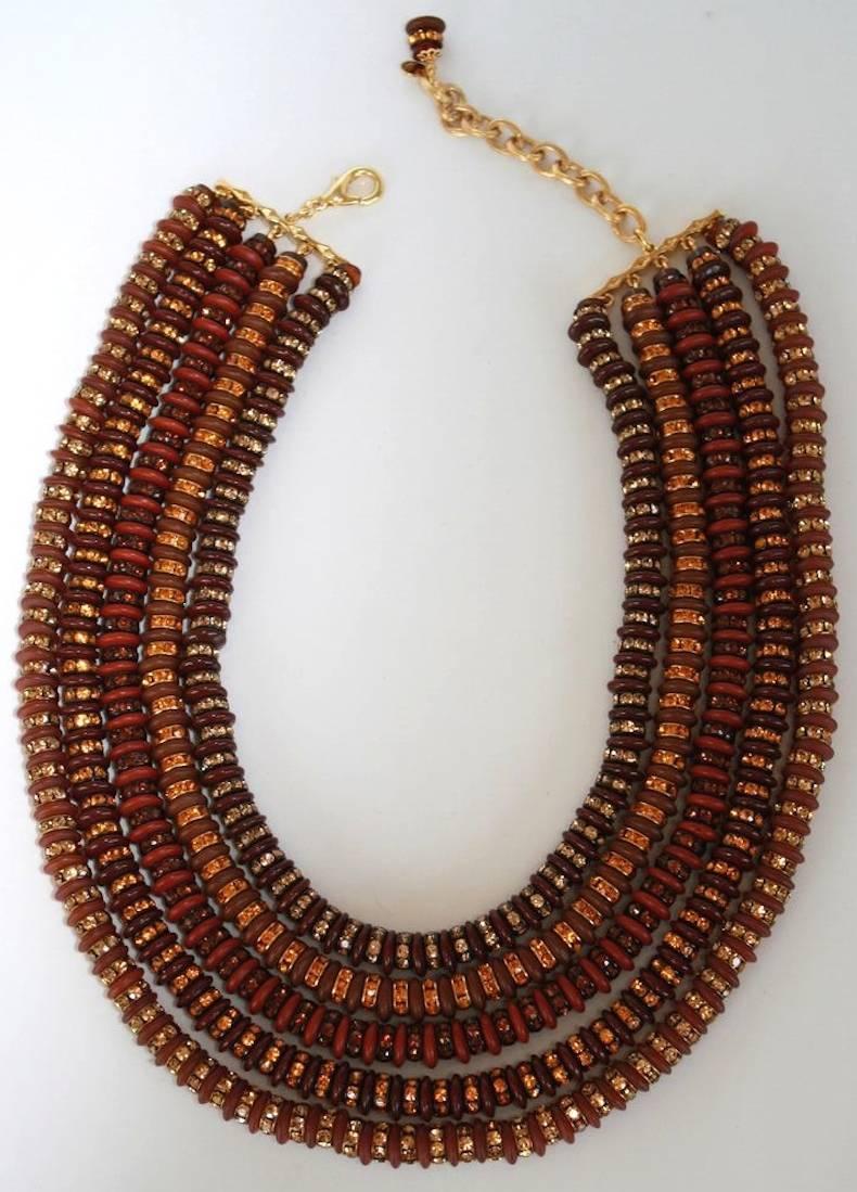 Burgundy and brown rondelles are strung between gold and clear Swarovski crystals in this five strand necklace from Francoise Montague. This piece is incredibly lightweight, despite its large stature. A gorgeous addition to any collection. 

15