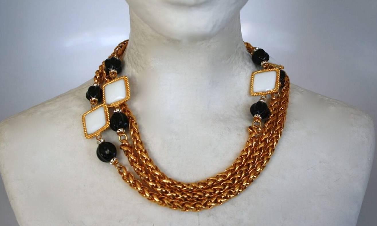  White and black pate de verre glass station necklace with Swarovski crystal rondelles on gold rope chain from Francoise Montague.

 29
