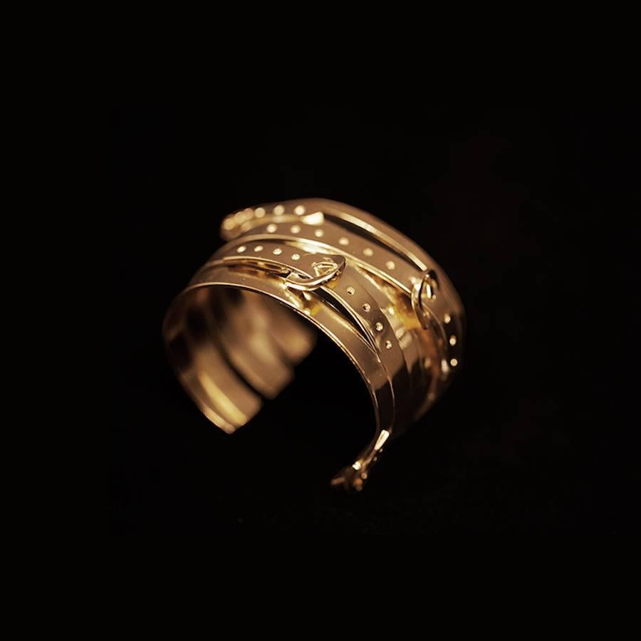 This multi buckle cuff bracelet is hand made in a Parisian studio where it is dipped in an 18 carat gold bath. Cuff is malleable and can be adjusted to fit most wrist sizes. 