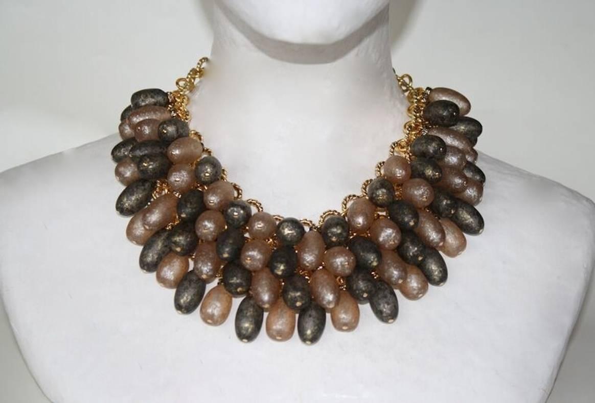 Francoise Montague necklace made with four rows of grey and gold handmade glass beads on gold chain.

14