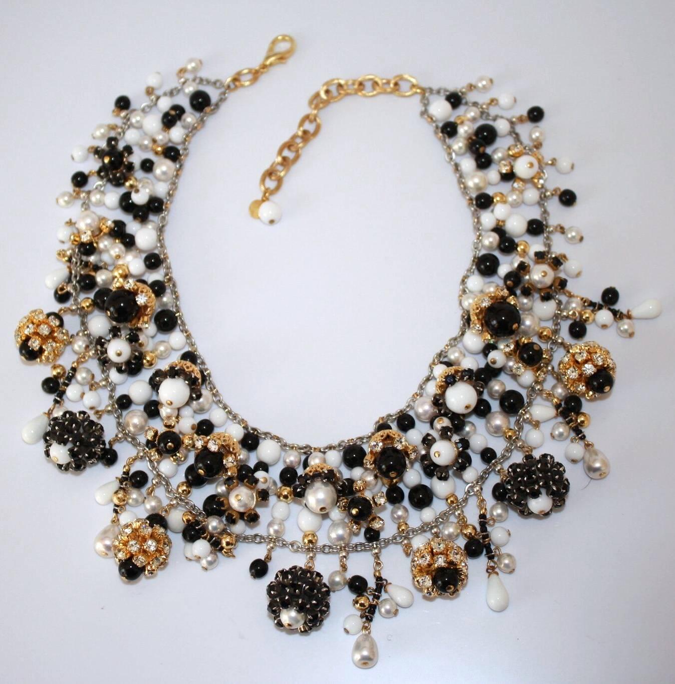 A famous style from Francoise Montague. Hand beaded collar necklace in chic black and white glass pearls with Swarovski crystal details. 

15