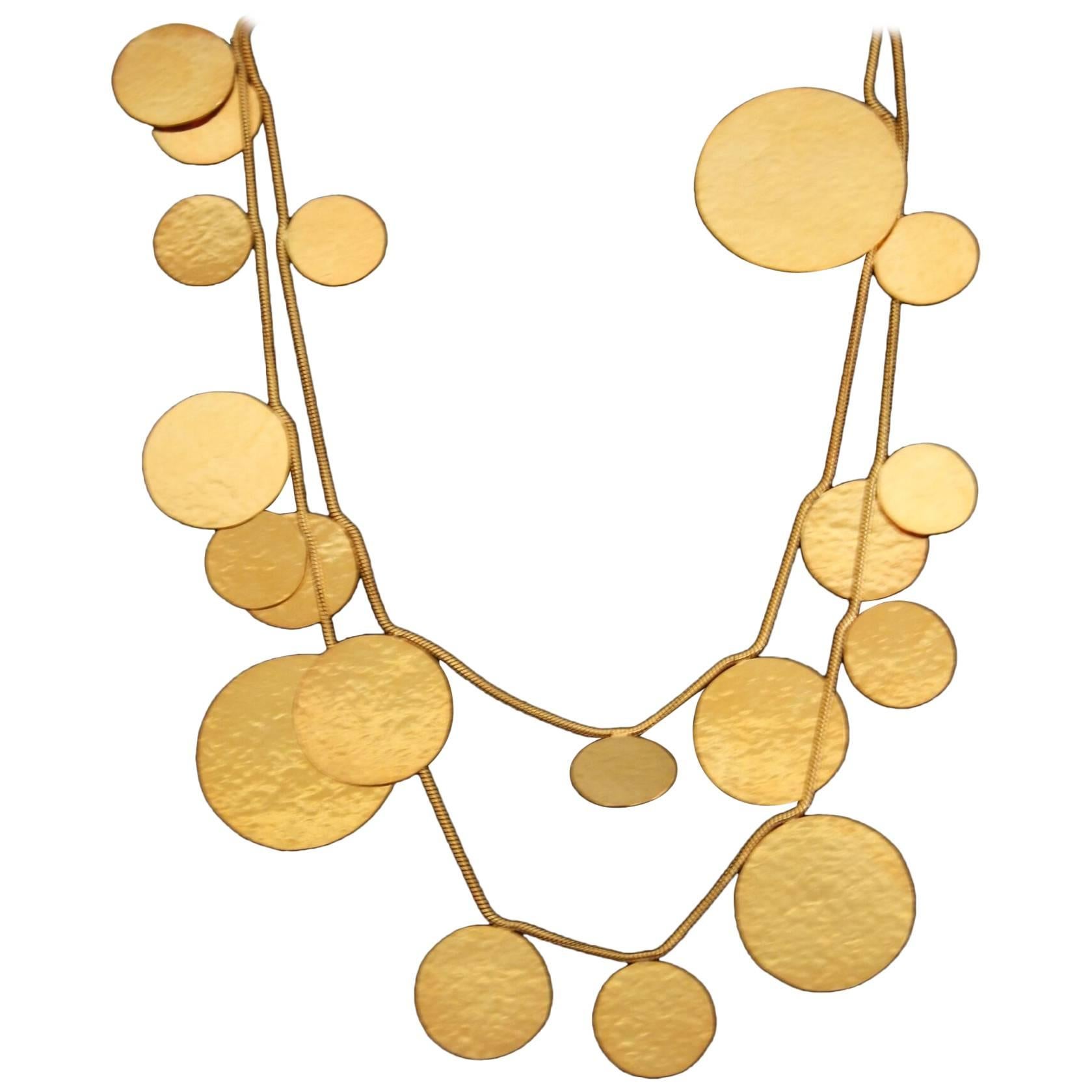 Long hand hammered gold plated brass sautoir necklace from Herve van der Straeten. Can be doubled or worn long - extremely lightweight. 

This designer is no longer producing jewelry, making all remaining pieces collector's items. As such, prices