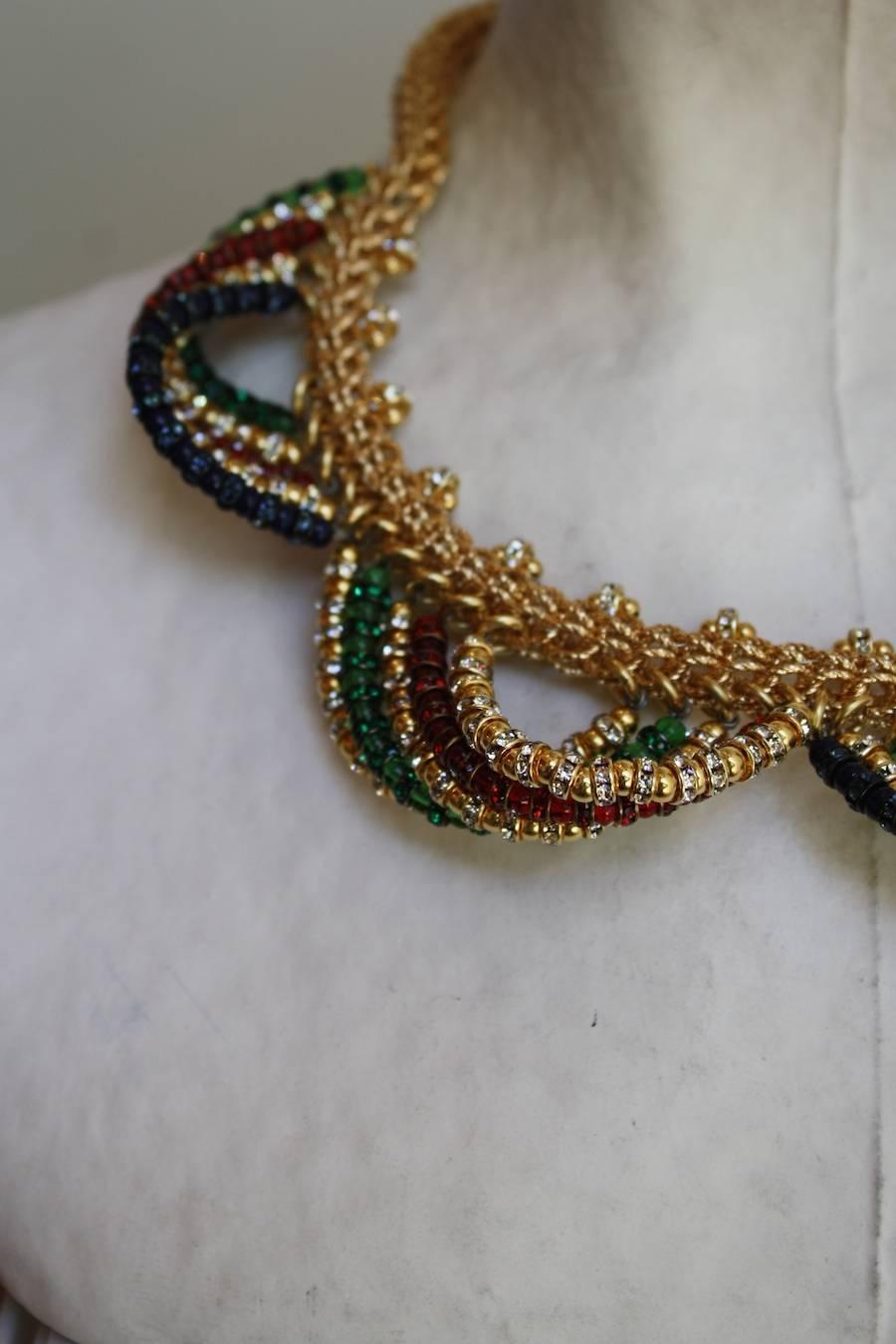 Gold chain necklace adorned with Swarovski crystal loops in varying colors. A chic statement piece, hand made in Paris by French designer Francoise Montague. 

16