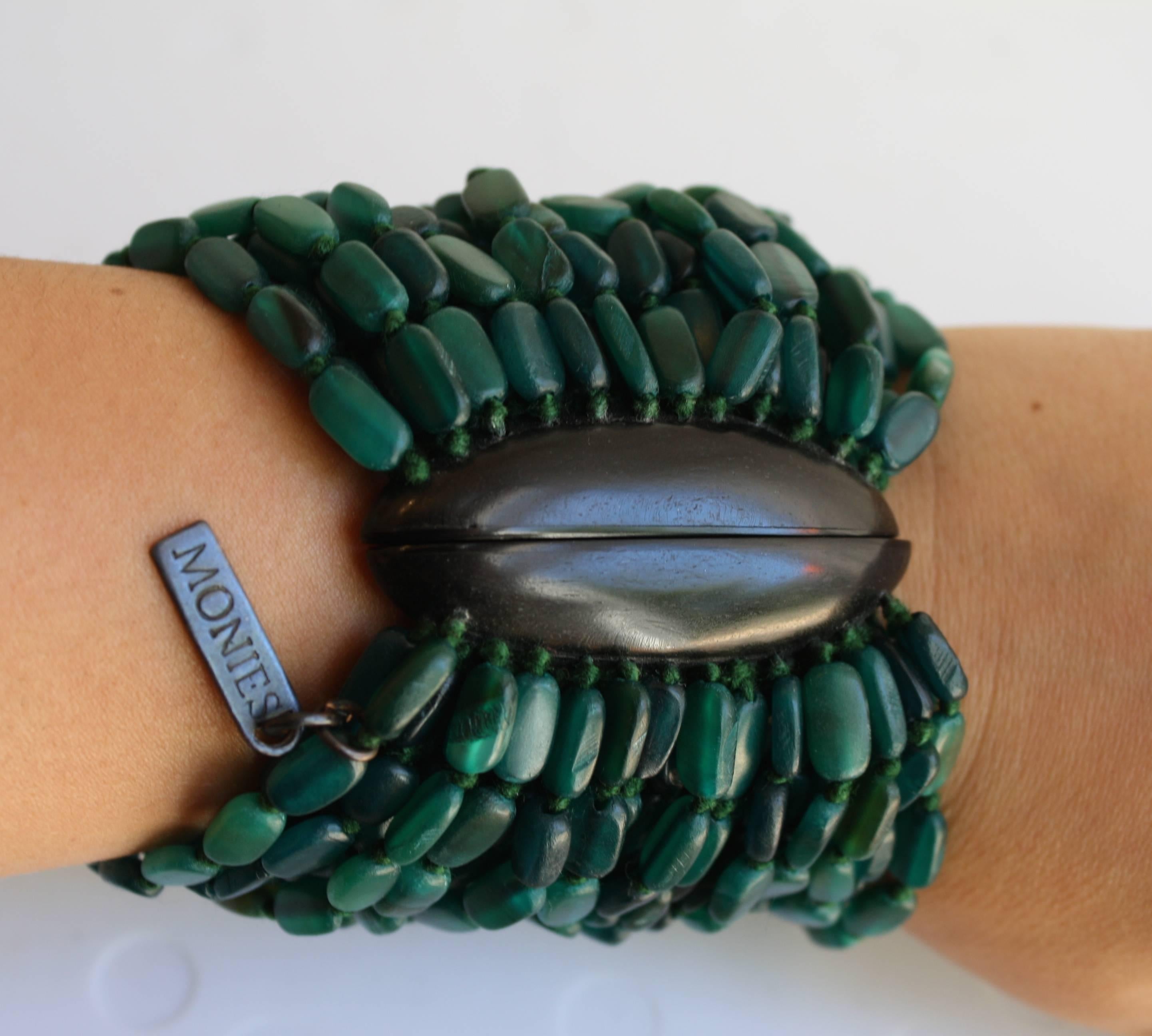 Multi strand dyed horn and ebony wood magnetic closure bracelet from Monies. 

3.75” width & 7.5” length
Magnetic clasp 1” width & 2.5” length

Designer Biography:

Monies is a Danish jewelry company founded by Gerda and Nikolai Monies. We