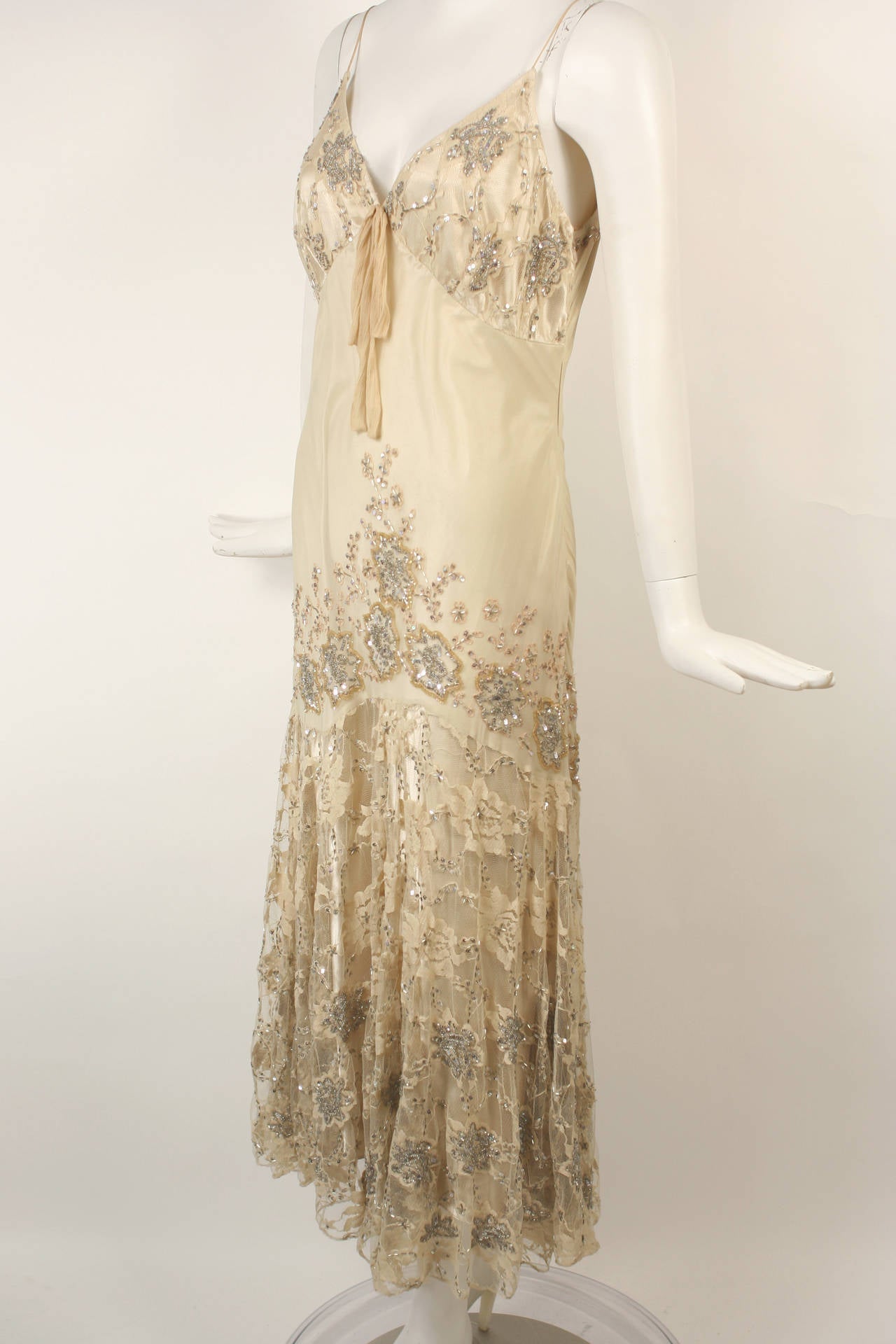 An exquisite gown by Valentino perfect for a special occasion. Vintage 1930 style cut with beading and sequins. Ivory/off white color. Bottom half of skirt made of beaded lace. This gown is cut on the bias therefore it could fit small through medium