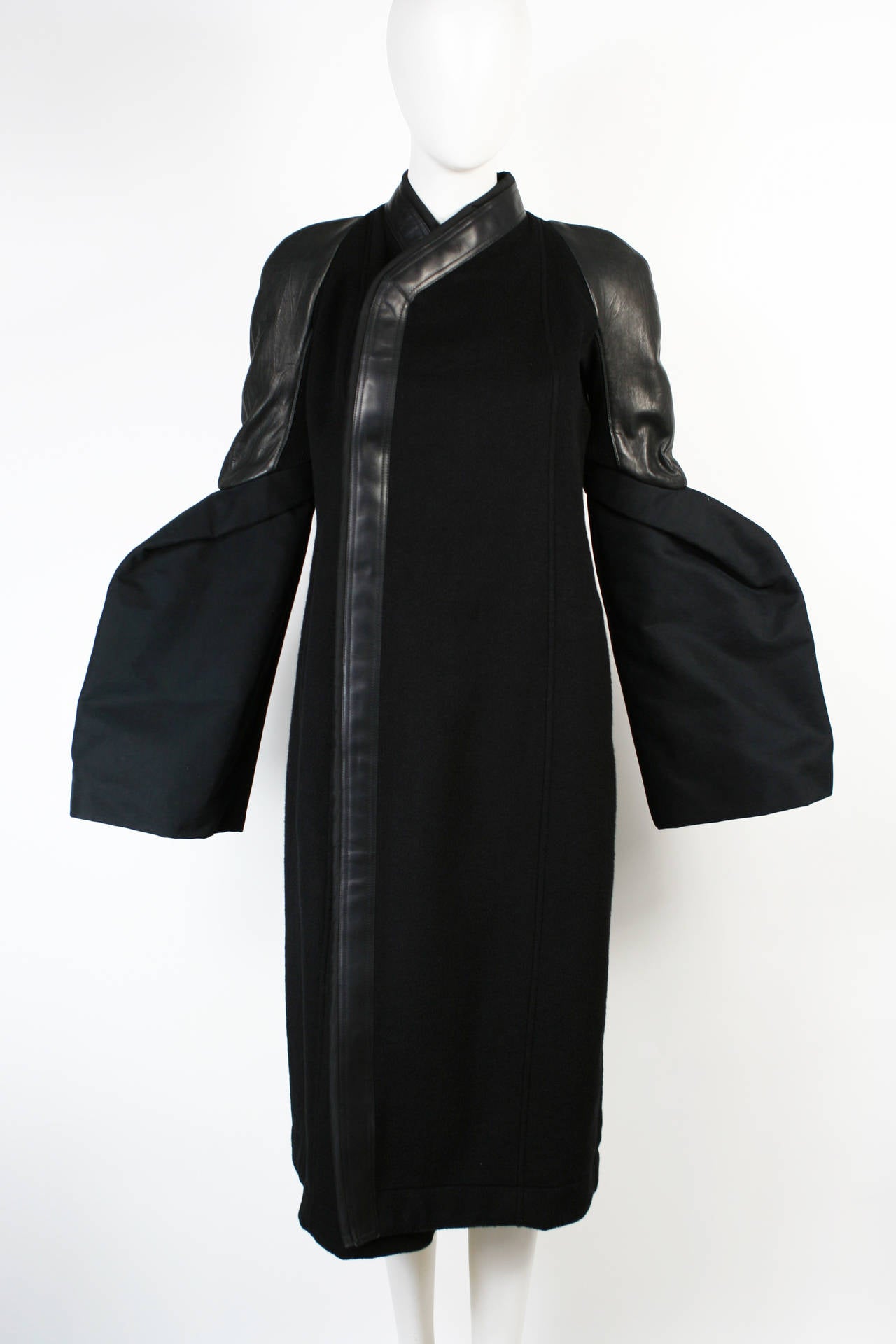Rick Owens Sculptural Black Cashmere Coat with Leather Detail. 
From the Plinth FW 2013 Collection. Fabulous sculpted sleeves made from cotton. Leather shoulders and trim. Highest quality cashmere. New With Tags.
Marked size 8 but would fit sizes