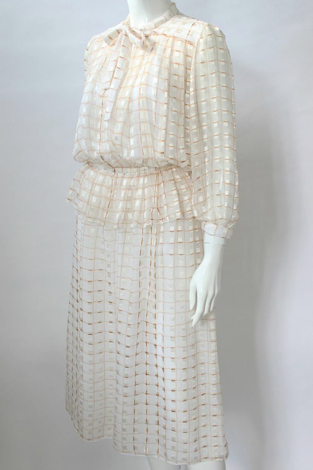 Courreges Paris 1970s Tan and Cream Silk Skirt & Top Ensemble 
Tan and cream stripe silk two piece vintage skirt and blouse set. Blouson pleated shoulder top has full cropped sleeves, keyhole opening with button and tie at the neck and a gathered