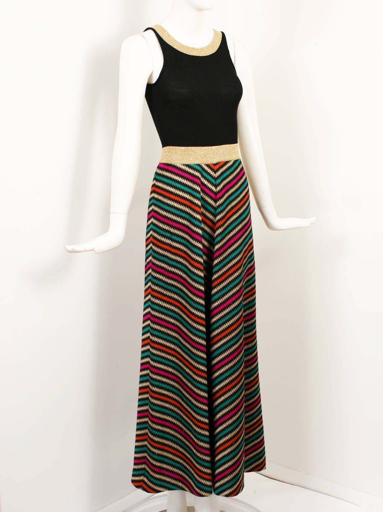 1970's Vintage Crissa Linea Italiana Knit Lame Maxi Dress. Zigzag pattern on skirt. Gold lame waist and neck band. Zipper up the back. Excellent Condition. 
x-small-small size.
Bust 28