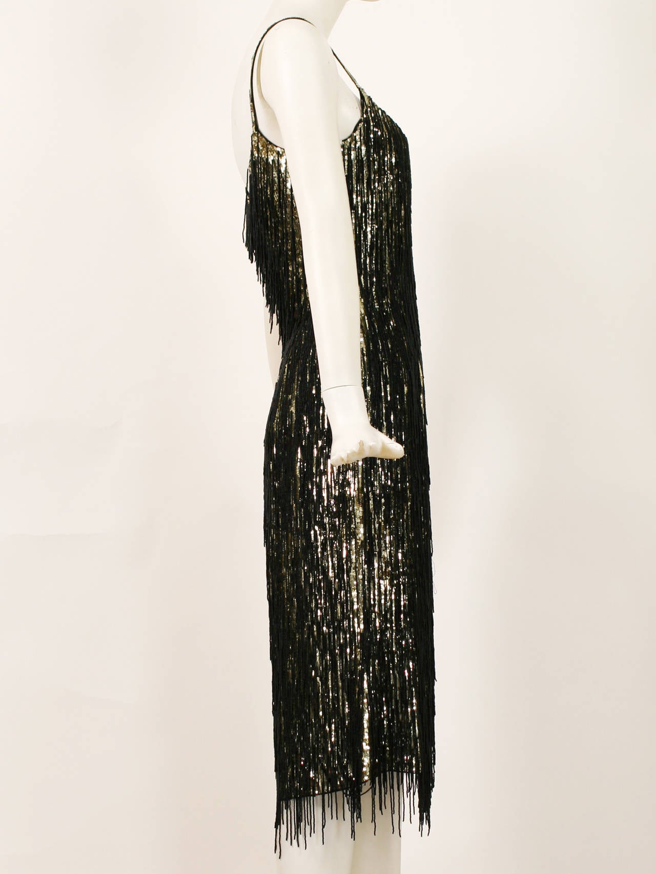 Magnificent Gold and Black beaded Fringe Dress by Escada. 
This dress is made of gold sequins with black fringe made of tiny beads. All hand worked. This is a truly and amazing dress. Excellent condition. 
Size 4
Bust- 34-35