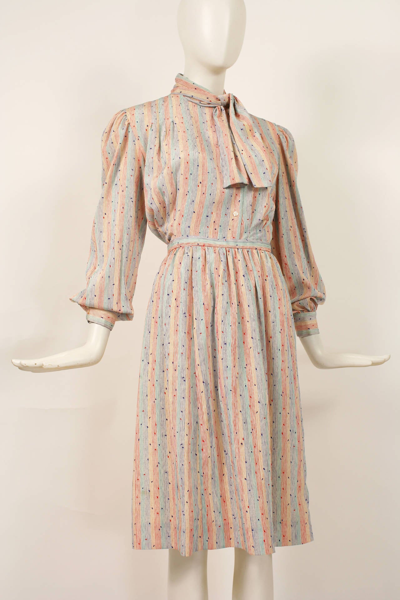 1970s silk Halston blouse and skirt ensemble. Multi colored pattern with white, blue, green,pink and red stripes. Bow at neck. Cuffed sleeves. Excellent condition. Size s-m.

Skirt
Waist- 25-26
