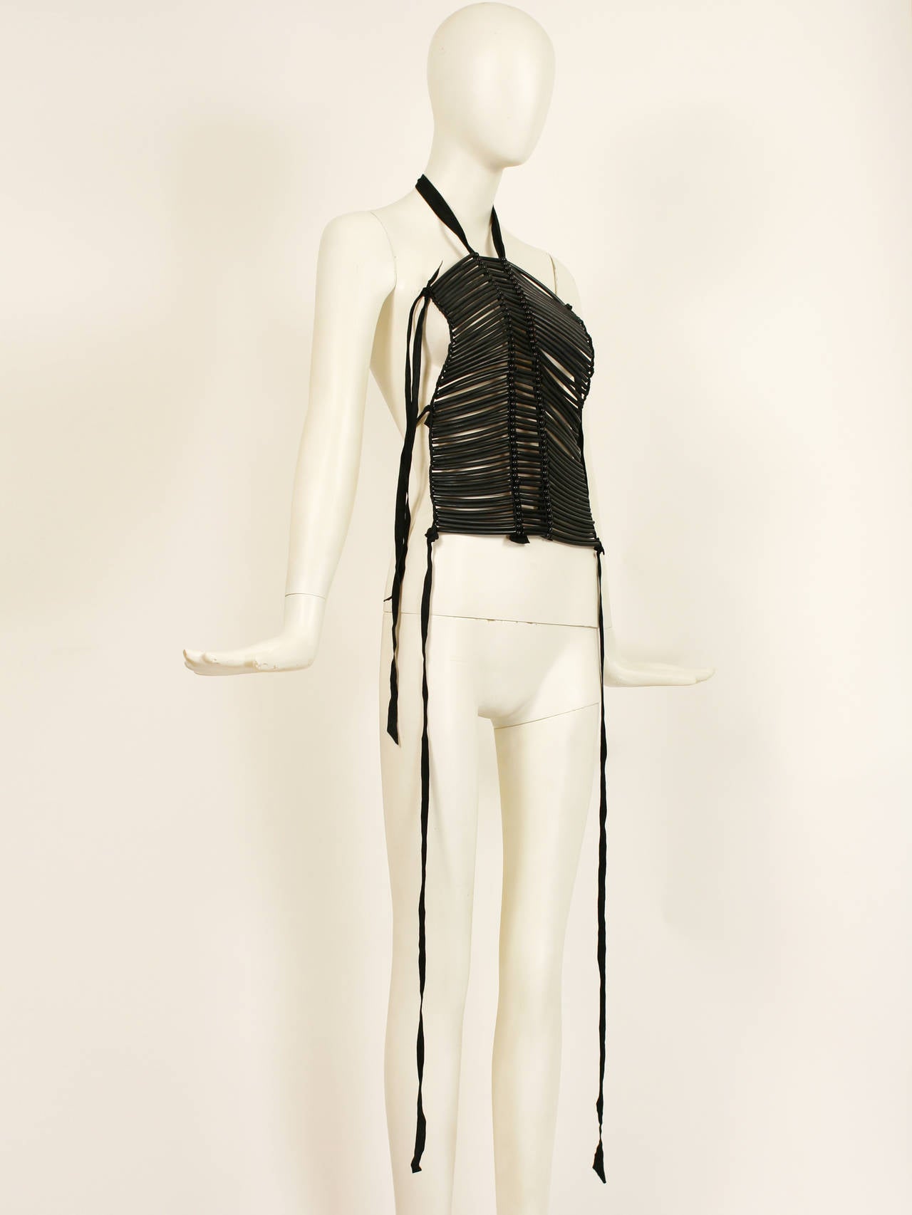 Helmut LANG black iconic breast plate top dating from 1991-92 when      Helmut Lang designed North American Indian inspired runway collections.  It is made up of rows of horizontal rubber tubes and beads, and secured by suede laces.  Excellent