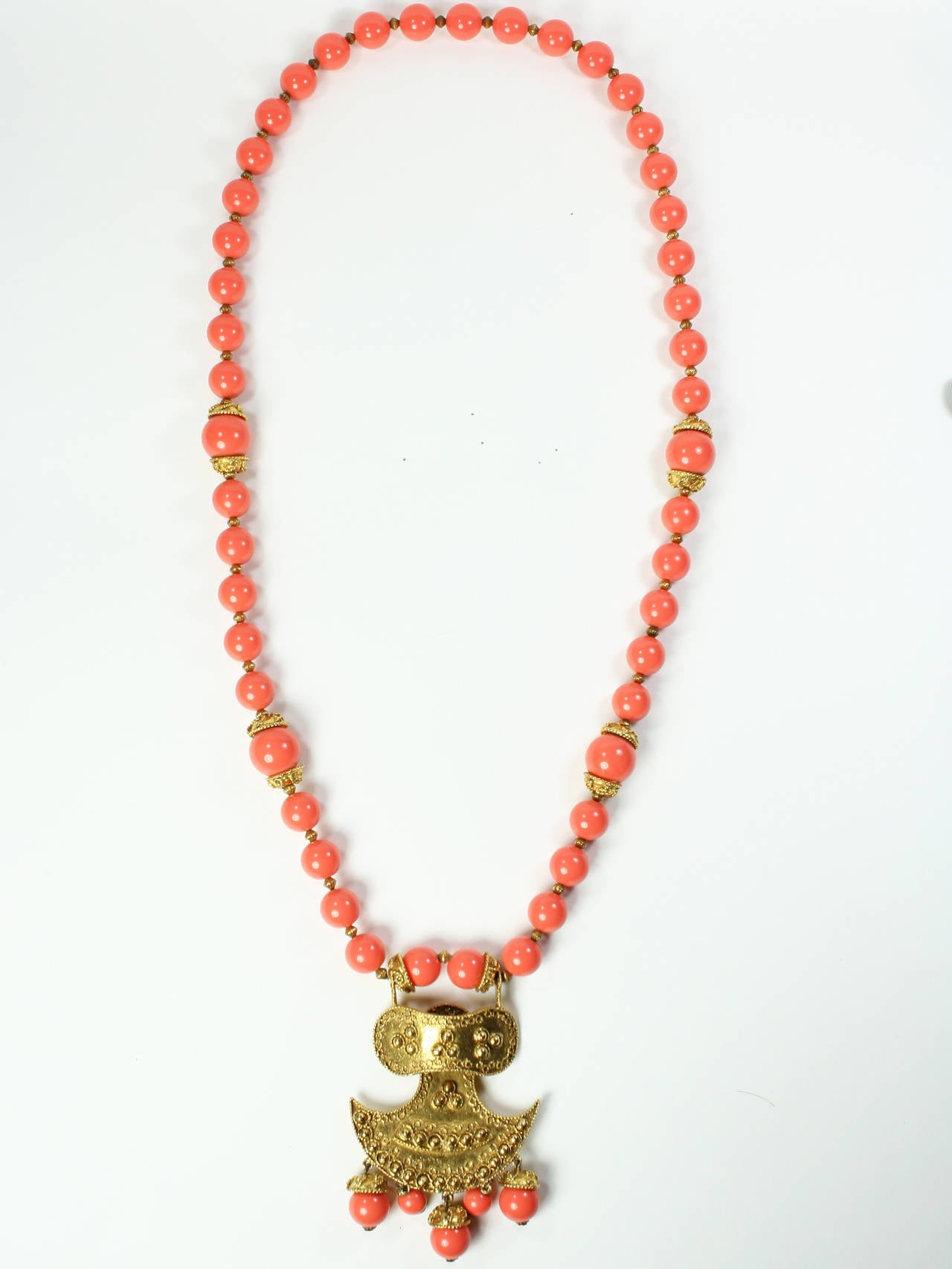 1970s Kenneth Lane Long Coral and Gold Resort Necklace.
Very long length. Thai/Balinese style with coral beads. A perfect 
resort accessory. Excellent condition.