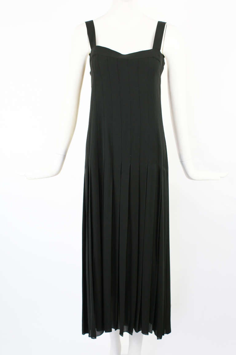 Chanel Classic Pleated Black Dress. Iconic Chanel gold buttons run though out the side back. From the 1989/90 Collection. Pure silk. Mint condition. Chanel / French size 38.