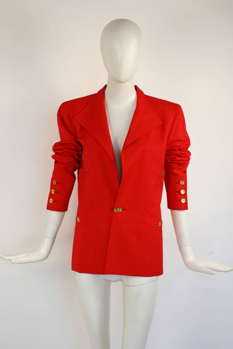 Chanel blazer in a very beautiful bright red color. Logo buttons throughout. Excellent condition. Chanel size 38. 
Length: 27