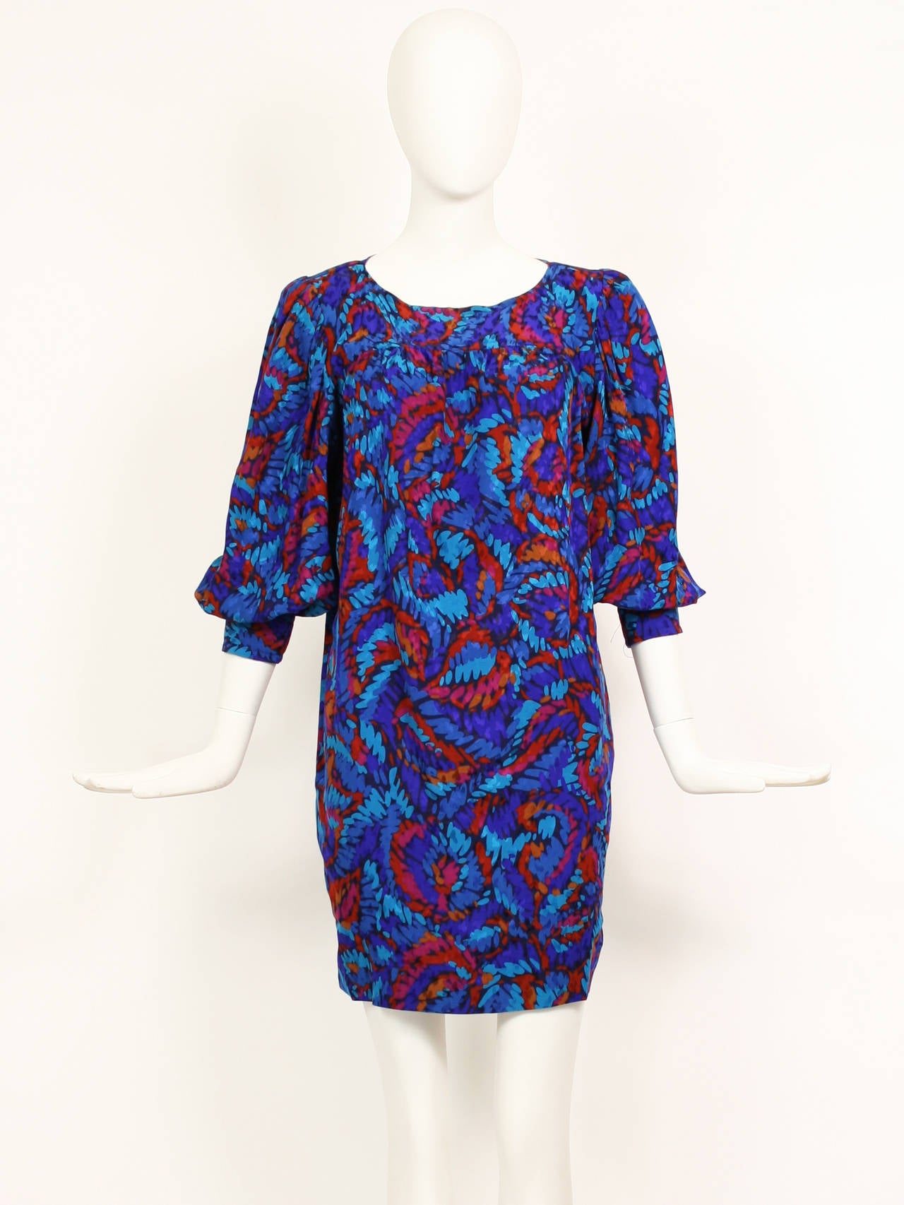 Vintage Yves Saint Laurent Silk Blue and Purple Print Dress with Blouson sleeves. Cuffs tighten elbow to create a puff effect.  Abstract print with blue , purple, and fuchsia. 
Excellent condition. 
Size 36
Bust:38