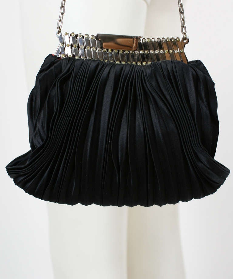 Valentino Black Pleated Evening Bag
Silk pleating with accordion frame and rhinestones.
Excellent condition