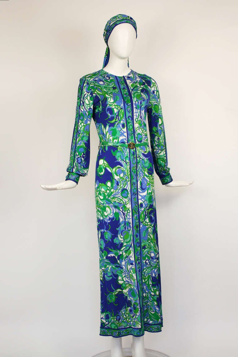 Emilio Pucci Blue and Green Dress and Scarf Set.
A fabulous set with a scarf that can be tied around the waist or head. Matching belt with gold Emilio Pucci logo. Button front. Very good condition with minor flaws. Silk and rayon blend