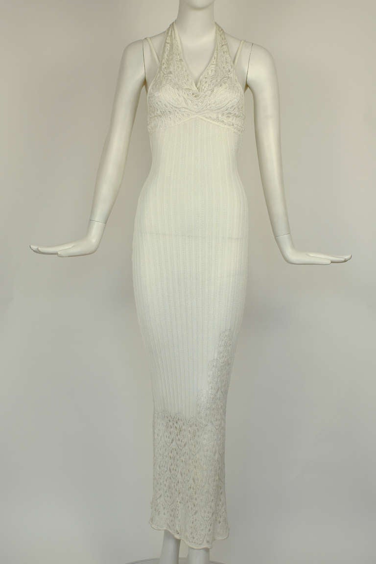 John Galliano White Open Knit Resort Dress

White lace knit dress with spaghetti straps and attached halter that ties at back of neck. Form fitting and perfect as a summer resort dress or beach wedding. Beautiful lacy knit sections. Made of rayon