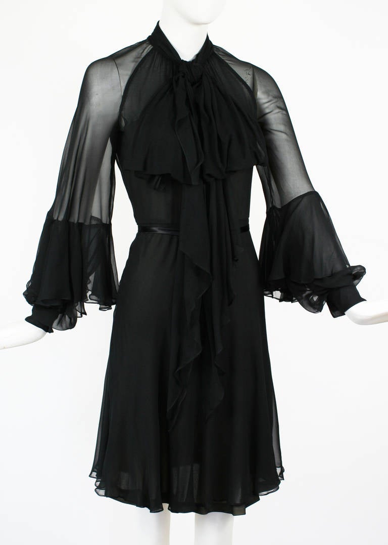 Christian Dior Black Chiffon Dress with Unique Blouson Sleeves. Cuffed blouson sleeves with dramatic flounce attached. Long attached pussy bow at neck. Silk chiffon through out with couture details.  Excellent Condition. 
Size small but there is
