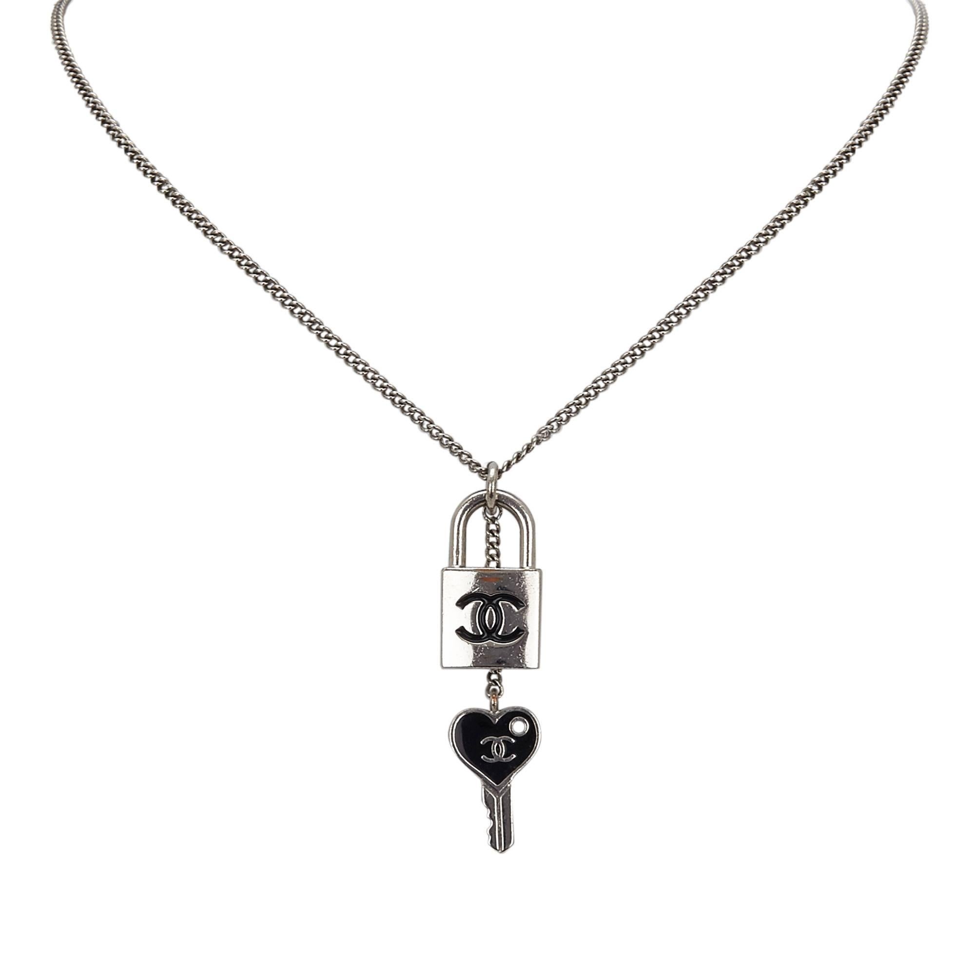 - This 2007 Chanel necklace features a "CC" padlock and a heart key pendant in a metal hardware, silver-tone neck chain, and a lobster claw closure. This can be a very special gift for couples! Key to your heart!

- Made in France. 

-