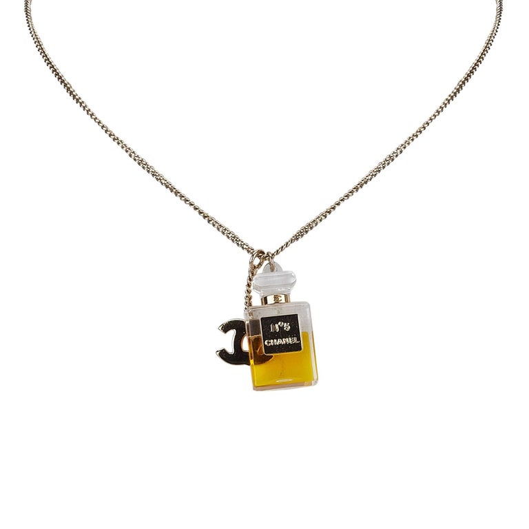 Chanel No.5 Perfume Bottle with Gold Toned "CC" Logo Pendants Necklace at  1stDibs | chanel no.5 perfume bottle necklace, chanel perfume bottle  necklace, chanel no 5 necklace