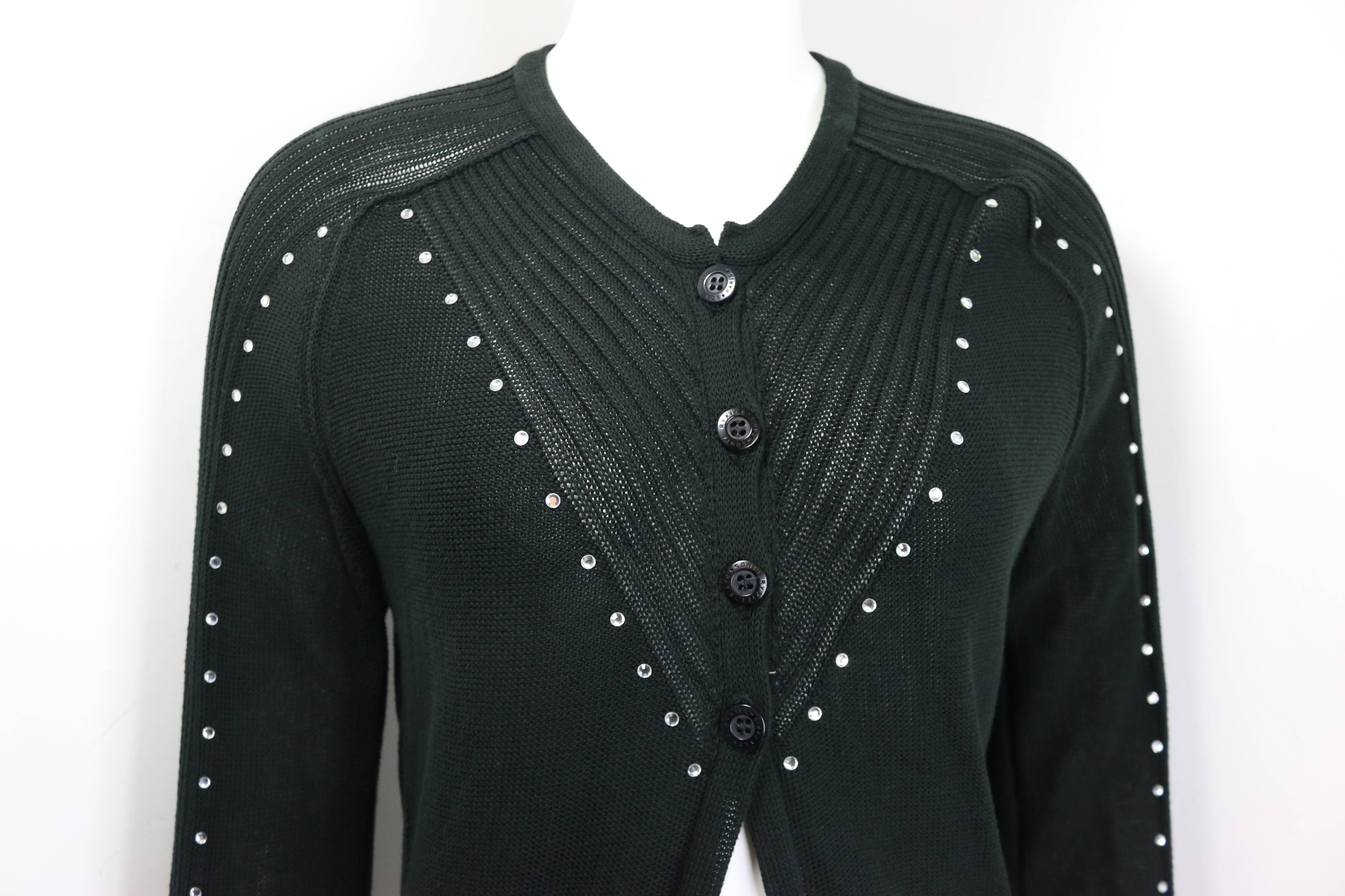 - Sonia Rykiel black cotton knitted long sleeves cardigan sweater. 

- Embedded rhinestones from front all the way to the sleeves . 

- Four front buttons closure. 

- V- neckline. 

- Size 40. 

- 100% Cotton. 


