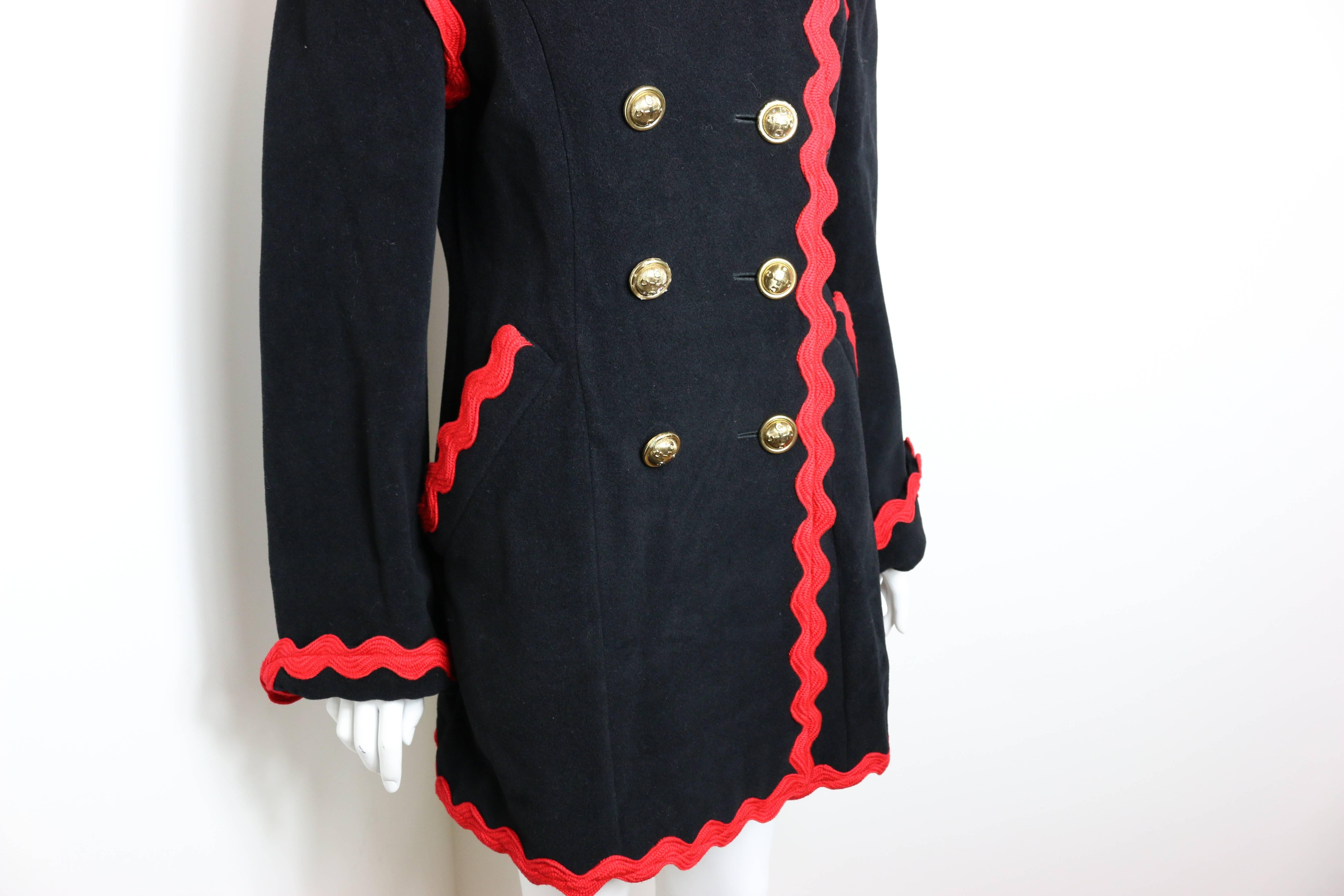- Vintage 90s Frank Moschino Cheap and Chic wool black with red piping trim double breasted coat. 

- Featuring ten panel front gold buttons. 

- Two red piping trim pockets. 

- Red sewn inside lining written 