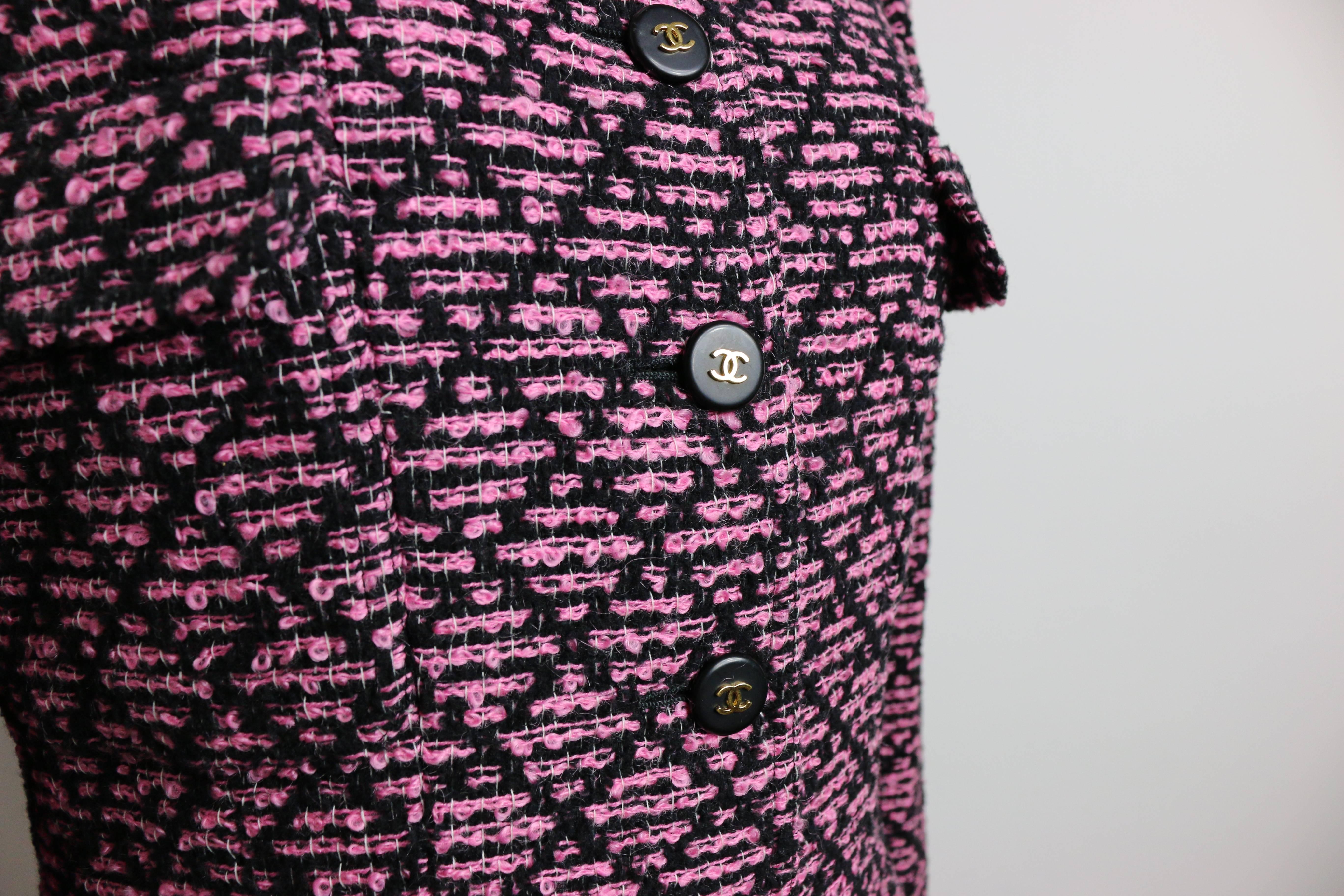 - Chanel black and pink boucle tweed long wool jacket from 1995 collection. 

- Featuring two front flap pockets and two front flat pockets. Six front 