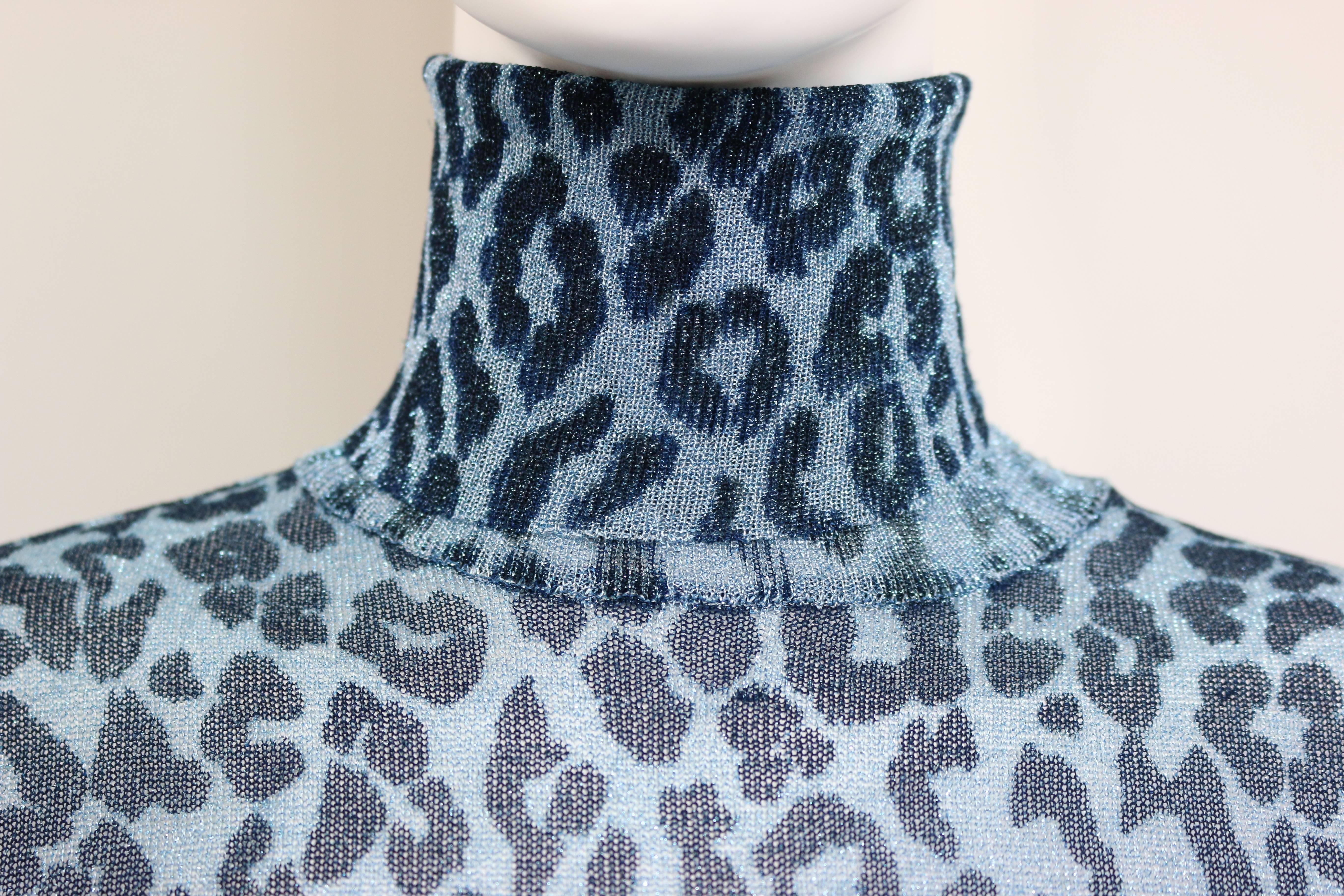 - Vintage 90s Dolce & Gabbana metallic blue and silver leopard-print turtleneck dress. 

- Sexy and body-hugging silhouette. 

- 66% Rayon, 34% Polyester. 

- Height: 27 inches. Sleeve: 22 inches.  Shoulder: 15 inches. Bust: 30 to 32 inches. 

-