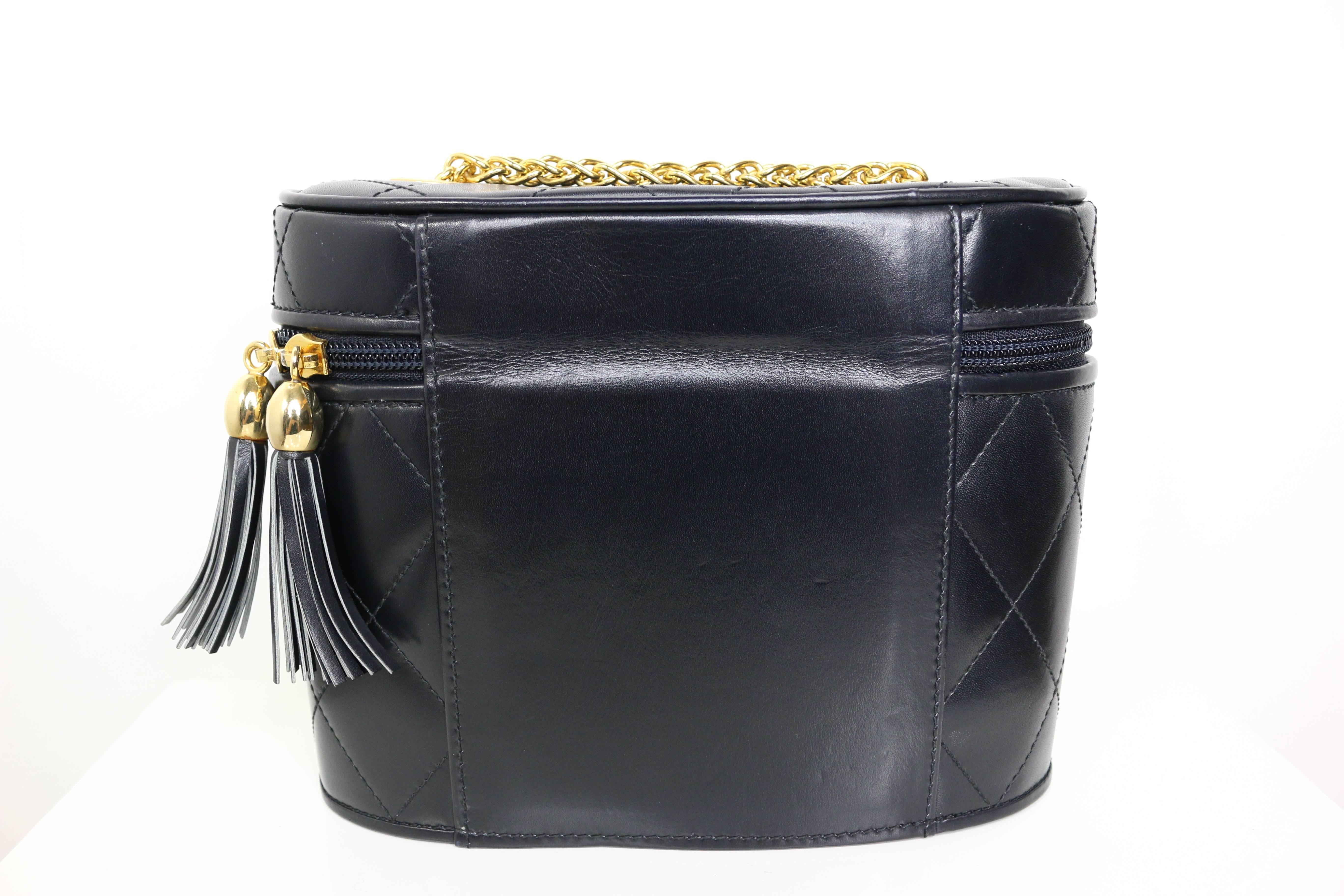 - Vintage Escada black leather quilted bag with gold chain and tassels closing. 

- Featuring gold ribbons hardware in front. 

- Height: 6.5in I Length: 8in I Gold Chain: 23.5in. 

- Made in Germany. 

- Condition: Excellent in preowned condition. 