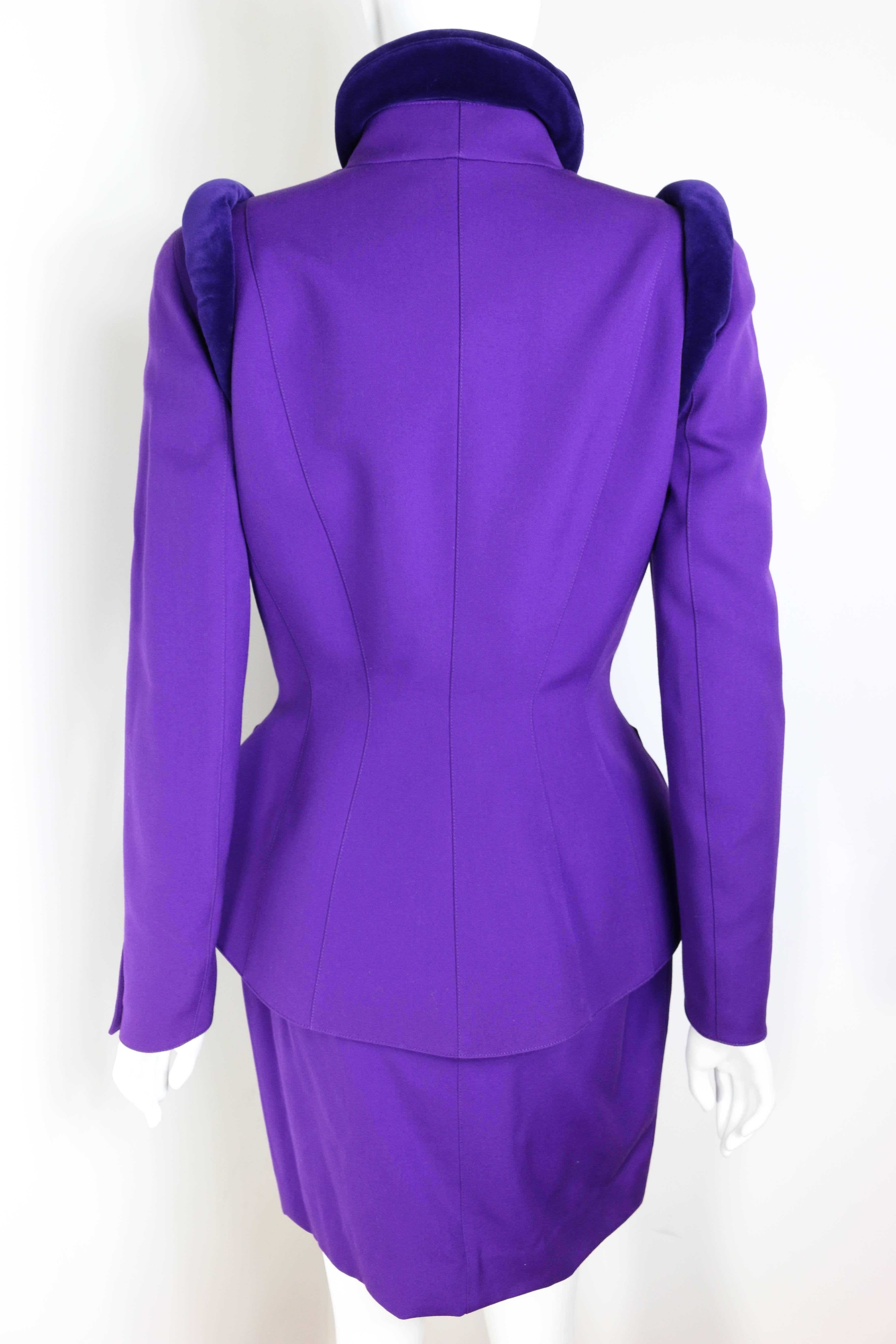 - Vintage 90s Thierry Mugler purple velvet crawl neckline and shoulder jacket and mini skirt ensemble. 

- Featuring four front snap buttons and one snap button on each cuff. 

- A very slight shoulder pads. 

- Fully lined. 

- Size 38