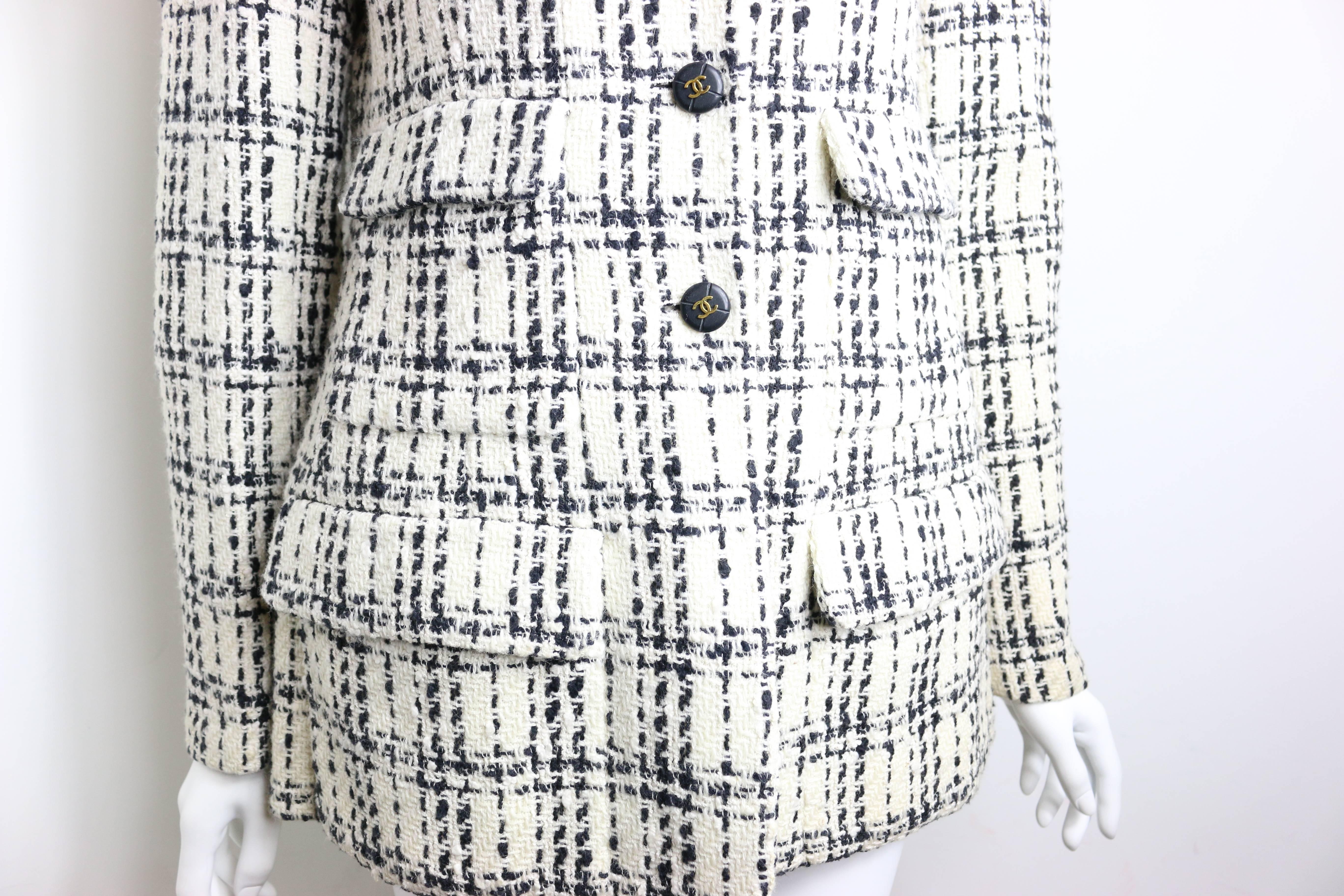 - Vintage Chanel classic black and white plaid pattern tweed cotton blend jacket. 

- Boxy cut with slightly padded shoulder. 

- Notched lapel. 

- Triple button-front closure. 

- Four Front flap pockets. 

- Button detail at cuffs.

- Fully