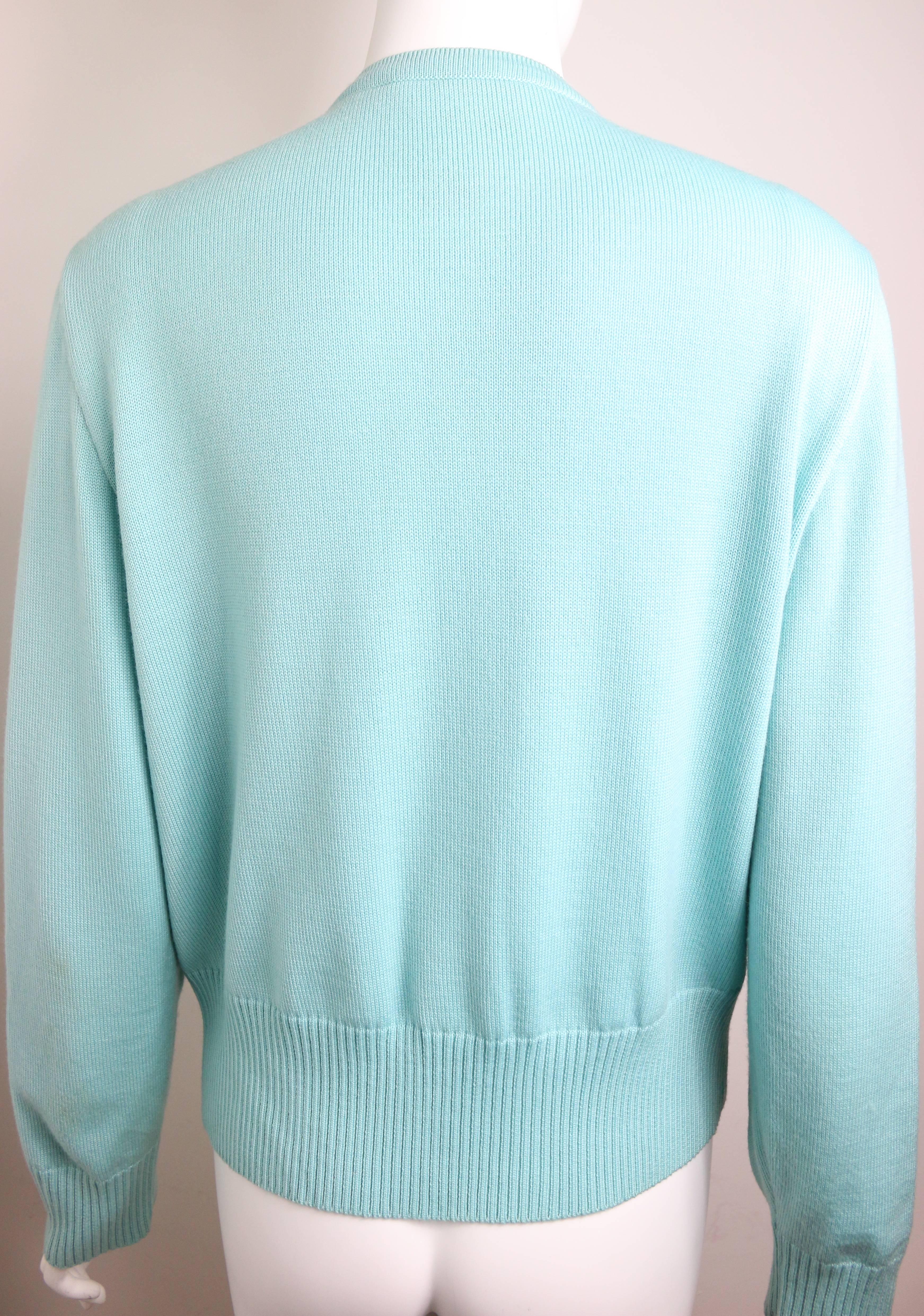 - Vintage 80s Escada mint green pearl cardigan sweater. 

- Made in Germany. 

- 100% Merino Wool.

- Size 38. 

- Shoulder: 16cm I Sleeve: 62cm I Bust: 36cm I Waist: 88cm I Height: 60cm. 