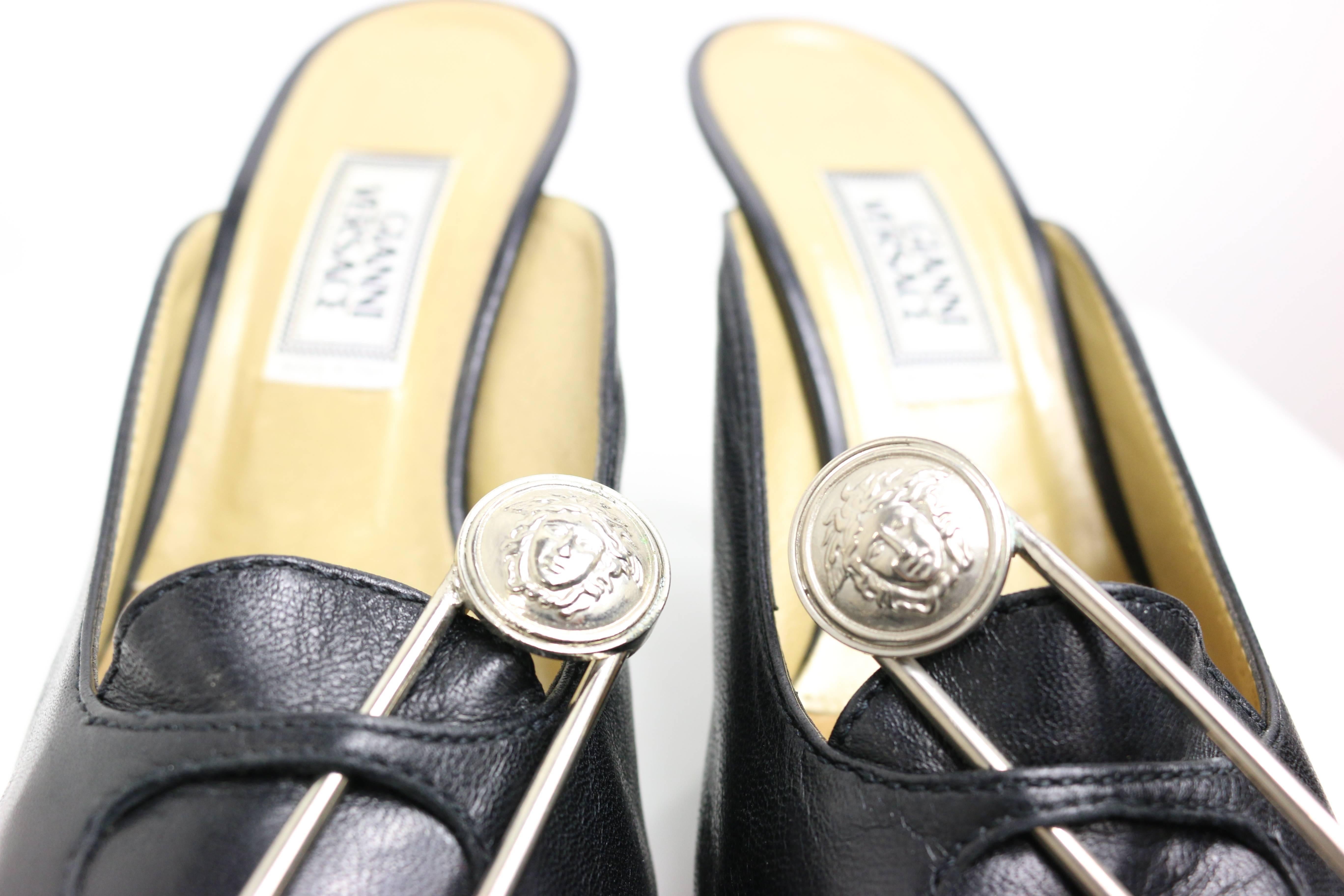 - Gianni Versace black leather iconic medusa safety pins mules from 1994 collection. 

- Size 37.5 

- Made in Italy. 

- Length: 23cm I Heels: 10cm. 

