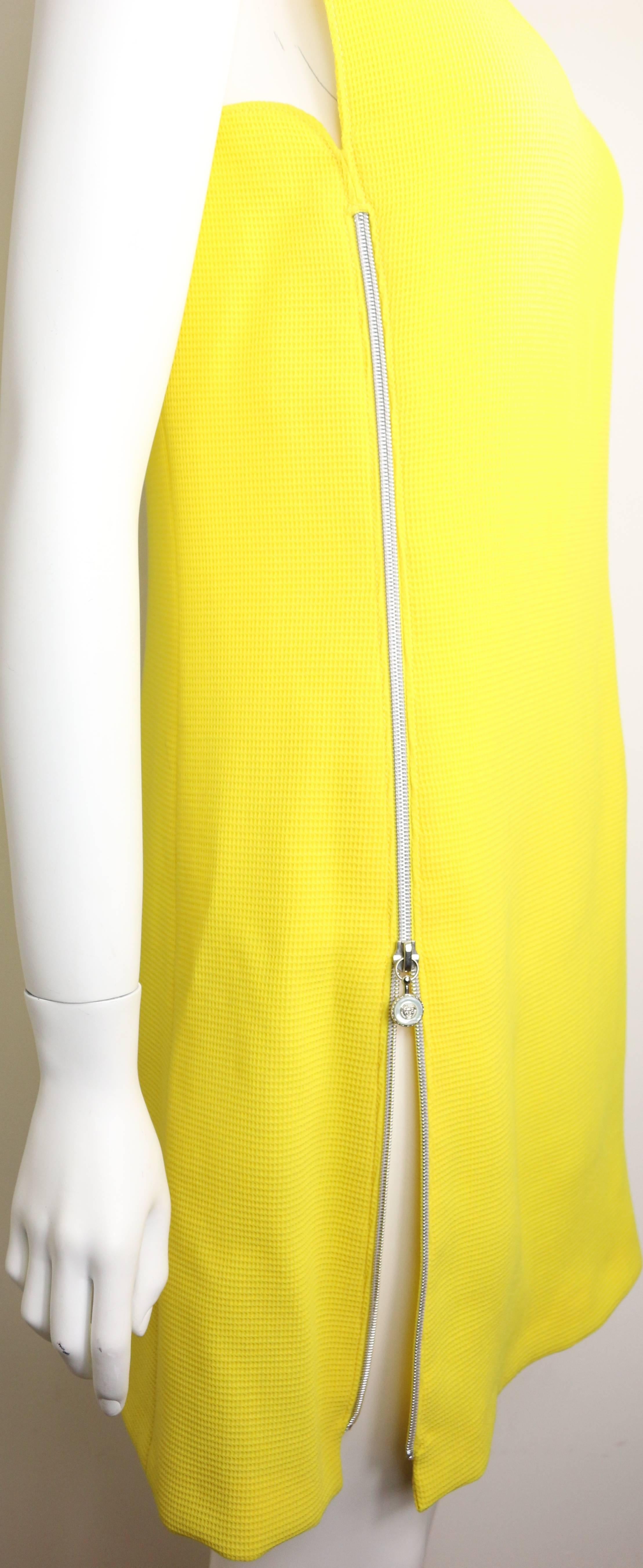 - 90s Gianni Versace Couture yellow dress with vertical Medusa zipper closing on the right and horizontal zipper closing on the left. Classic cut with a twisted. 

- 87% Wool, 13% Silk. 

- Height: 33.5in I Bust: 33in I Waist: 32in

- Size 38. 

-