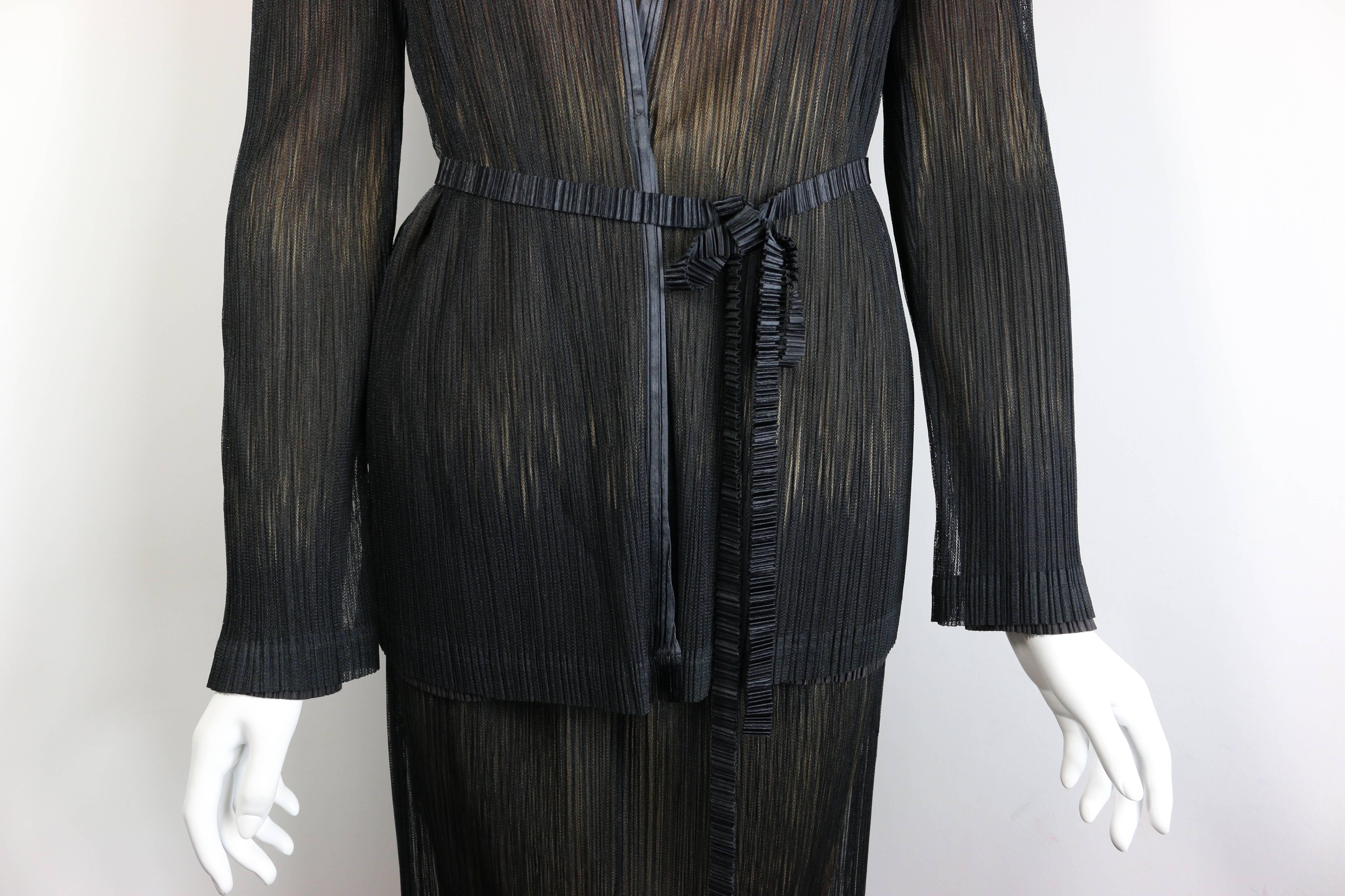 - Vintage 90s Issey Miyake double layers black mesh on top and beige/brownish/gold/black second pleated layer jacket and skirt set.
  
- Featuring a black pleated belt and a hidden button on the jacket. 

- Size M. 

- 100% Polyester 

- Jacket: