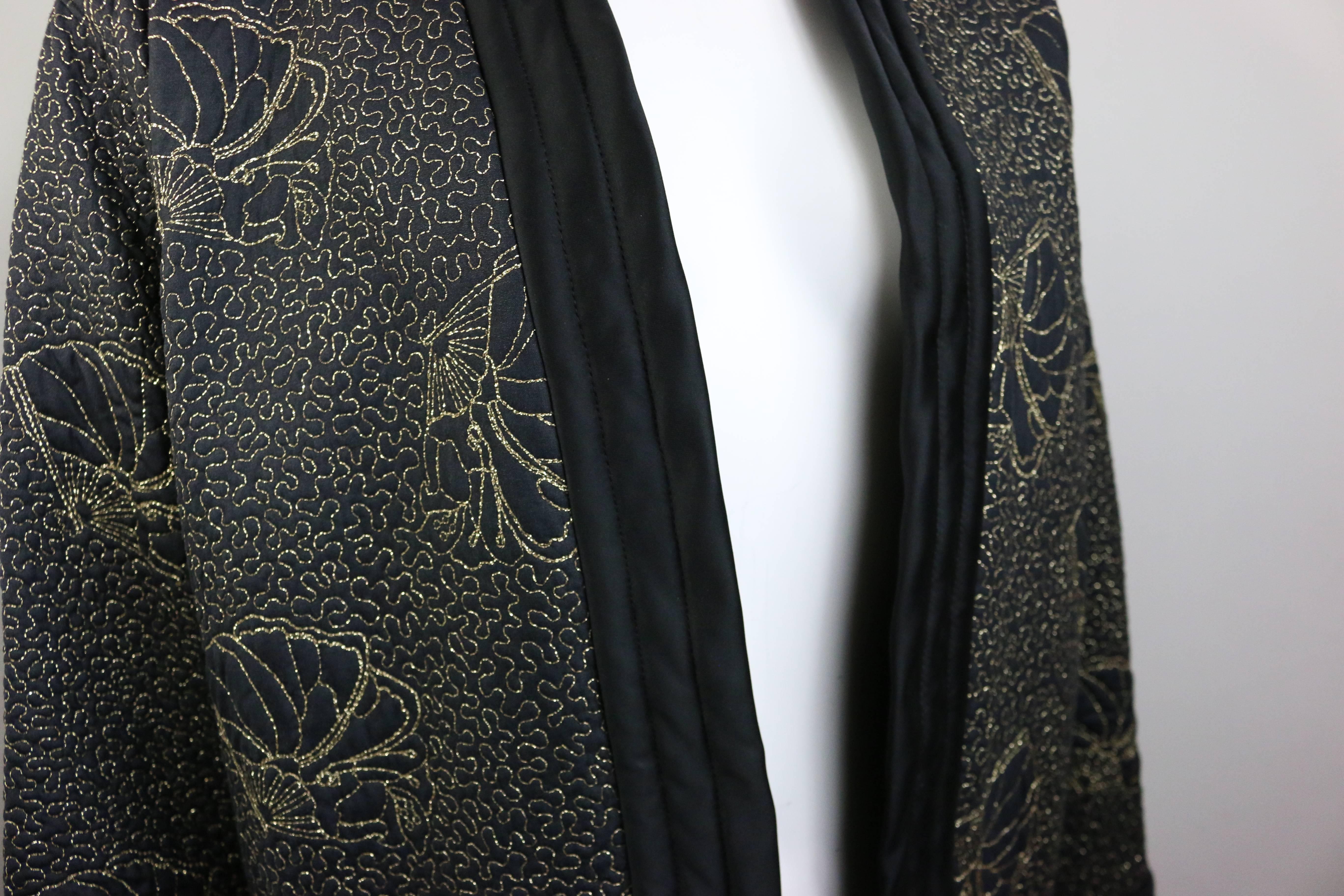 - Vintage Yves Saint Laurent Rive Gauche black evening jacket in quilted silk with gold embroidered "butterfly" motif. c.1982. 

- An Asian inspired jacket with no closures. 

- Featuring two sides pockets and bell shaped sleeves.

-