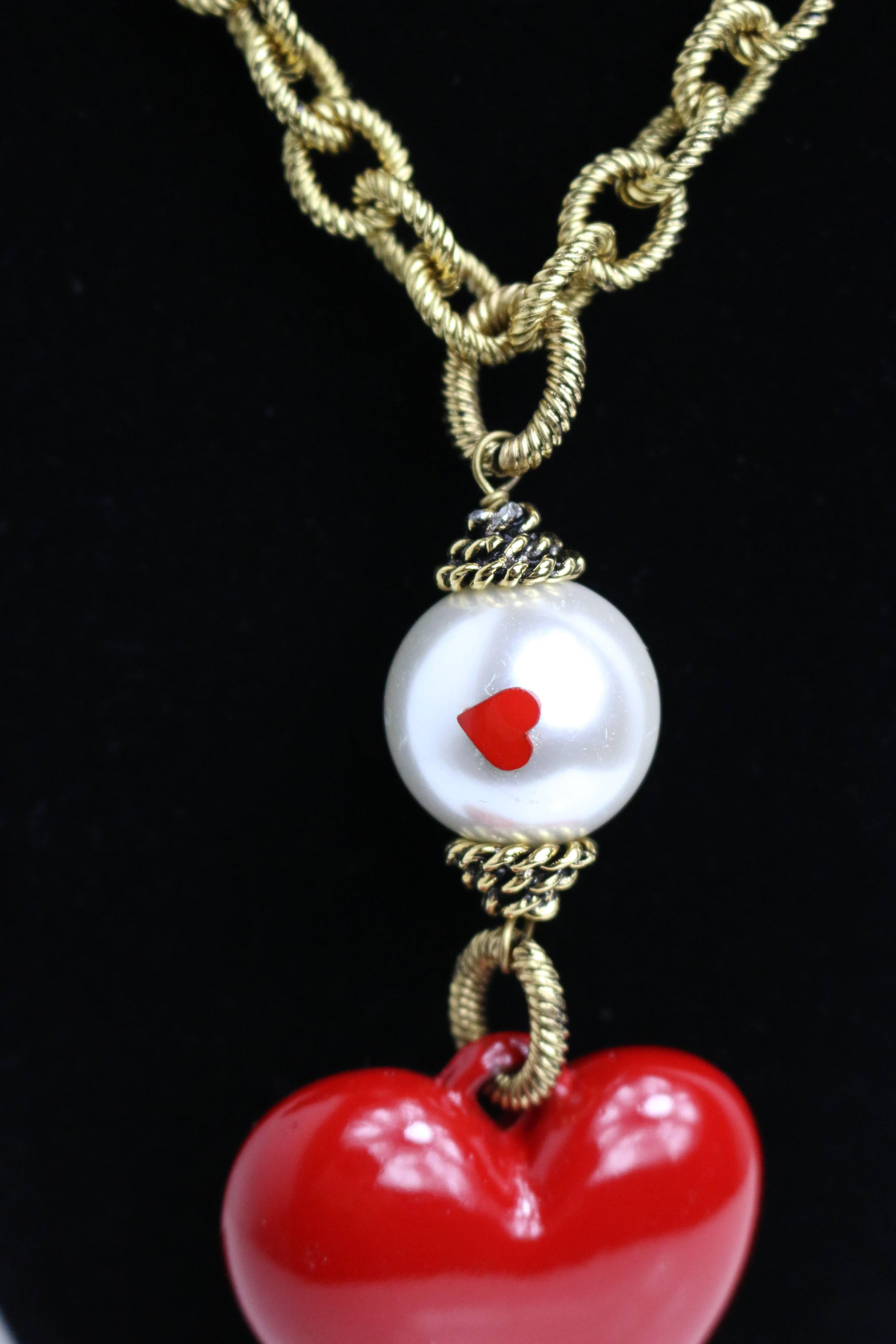 - Vintage 90s rare Moschino faux pearls with heart shape pendant gold metal cable chain necklace. 

- Featuring five faux pearls with two hearts on each, a plastic heart shape pendant and clasp fastening. 

- Made in Italy. 

- The Whole