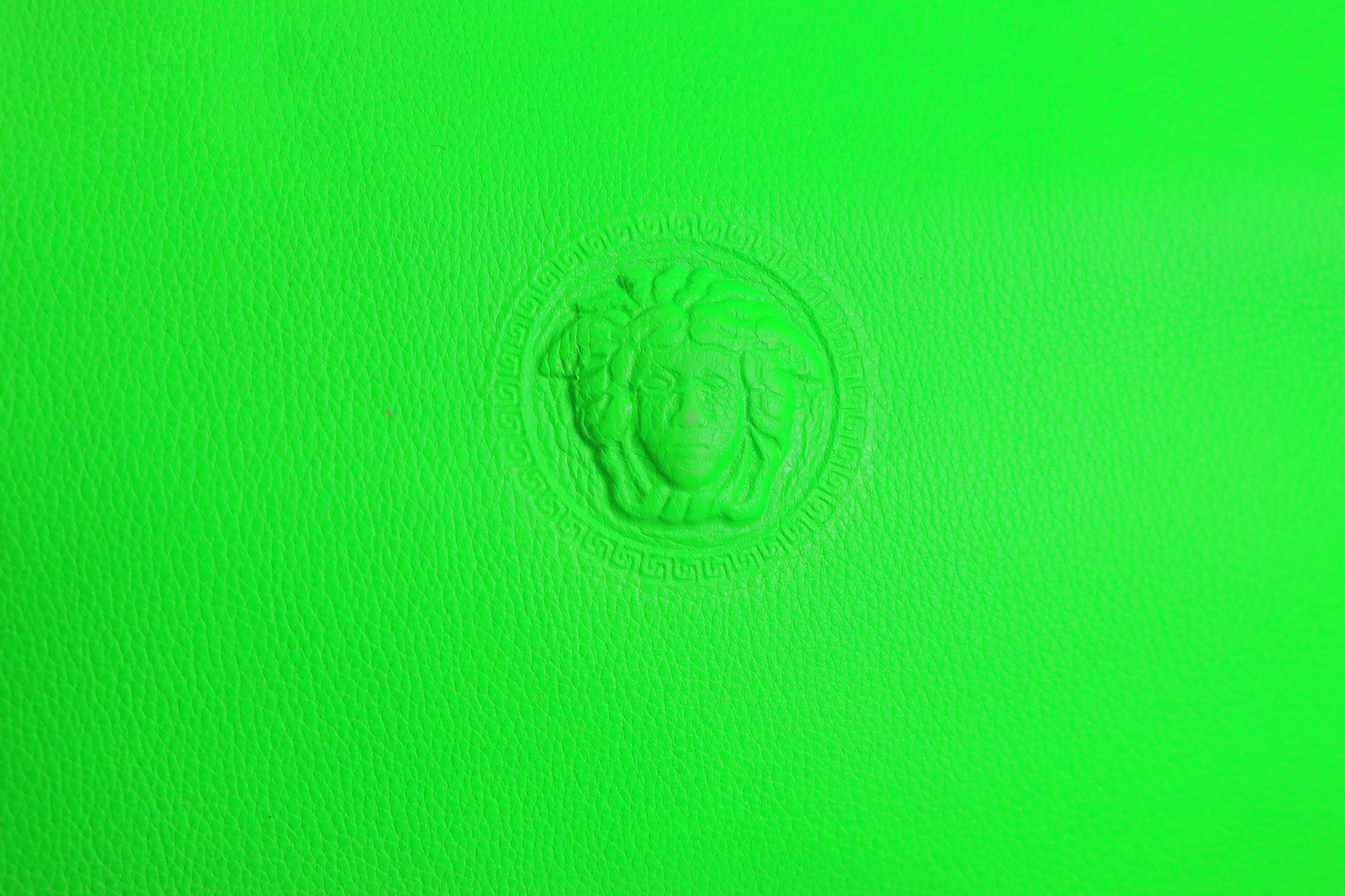 - Vintage 90s Gianni Versace Couture neon green leather bag with iconic Medusa logo. 

- Made in Italy. 

- Length: 11in, Height: 9.5, Handle height: 4in, Width: 3.5in (measurements are approximate). 

- Condition: Never been used before but some