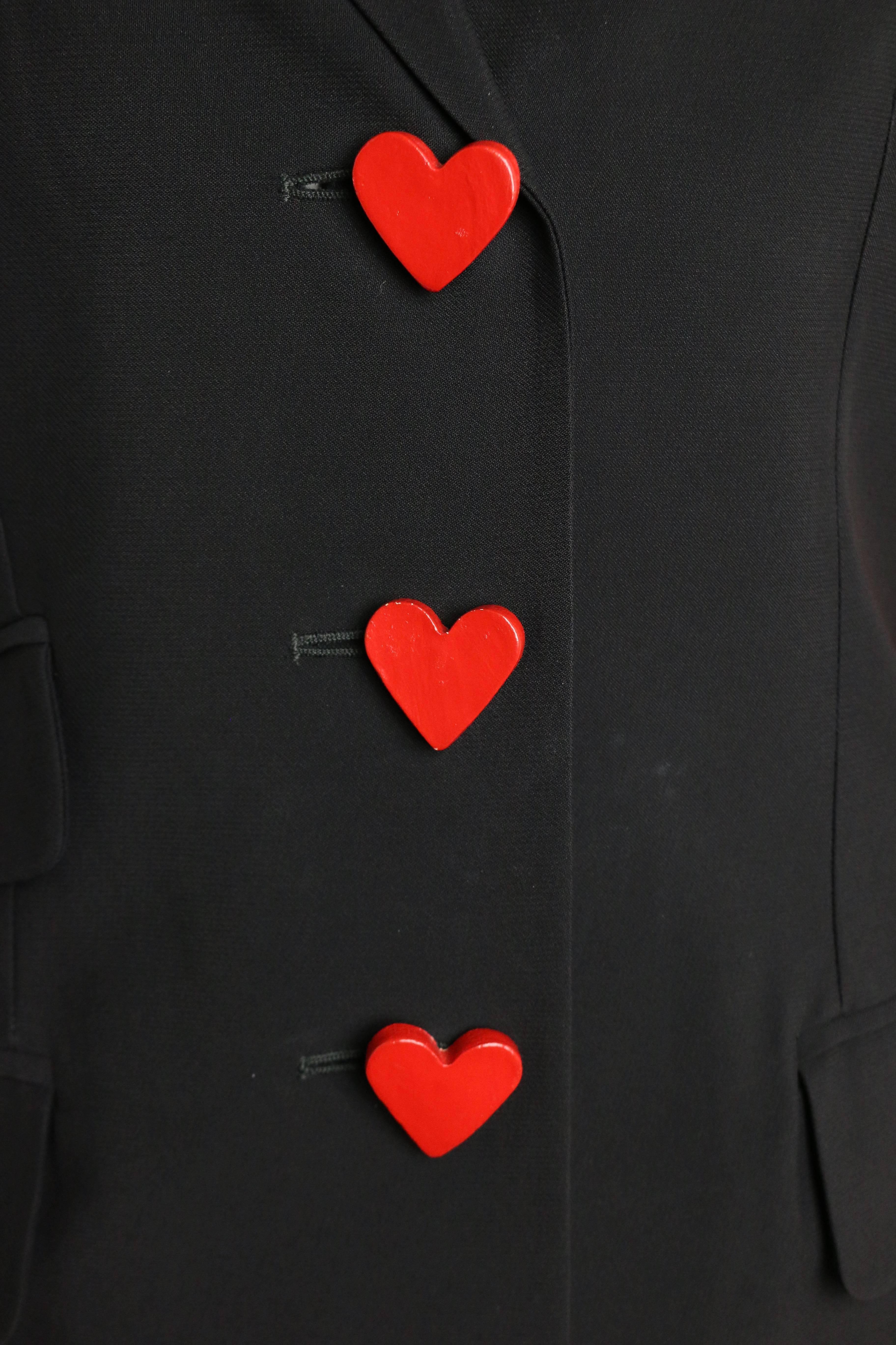 - This one of a kind avant grade vintage 90s Moschino Couture black jacket is beautifully done.  Featuring one shoulder of multicolour patchwork with three black/white swirled buttons at the cuff. Three wooden red heart buttons in front fastening