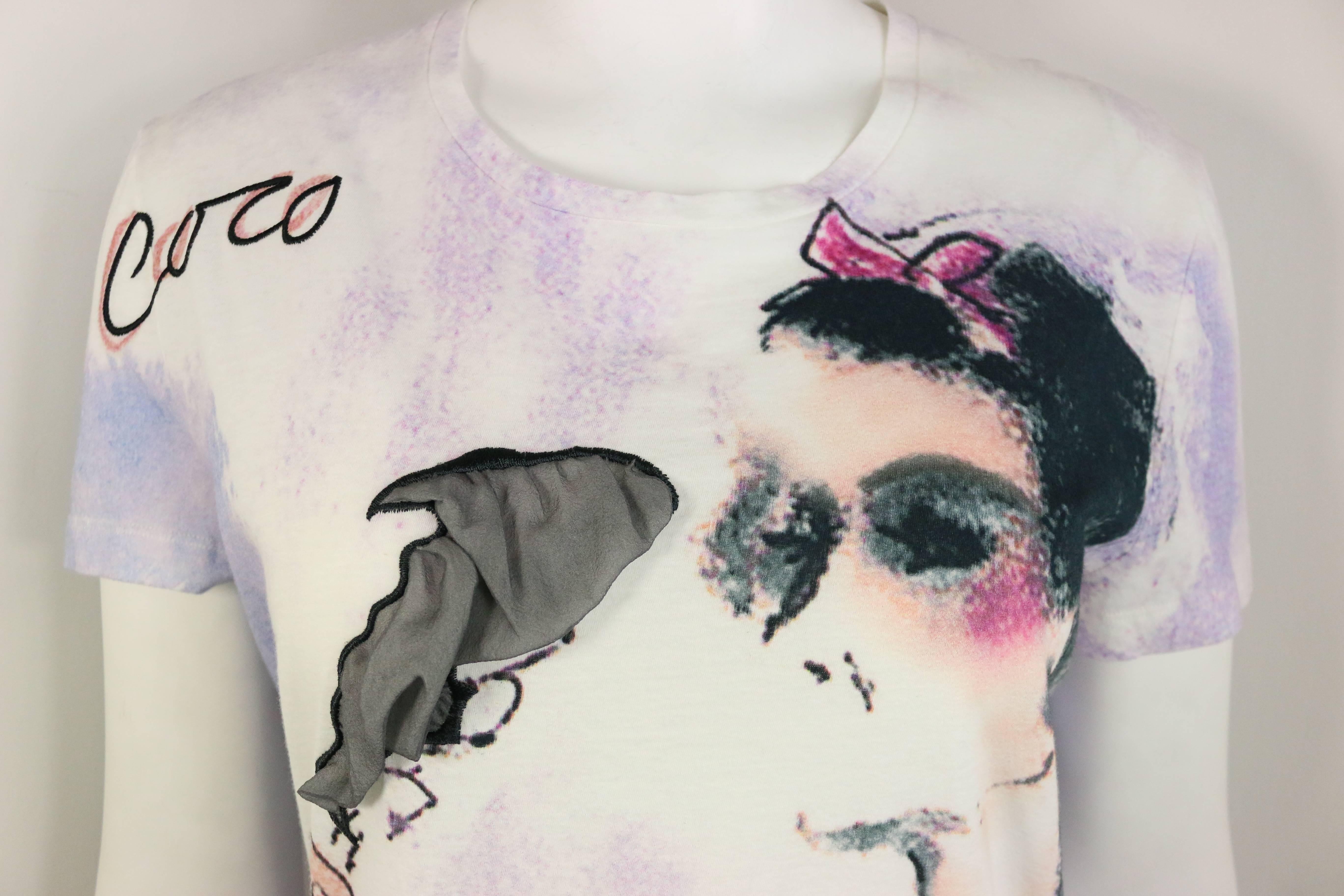 - This chic and rare Chanel t-shirt with Coco Chanel smoking print is a good collectable item. The smoke is in grey silk fabric.  Also, the t-shirt has some dye print (purple, blue and white) effect all over. Looking chic with jeans and jacket!